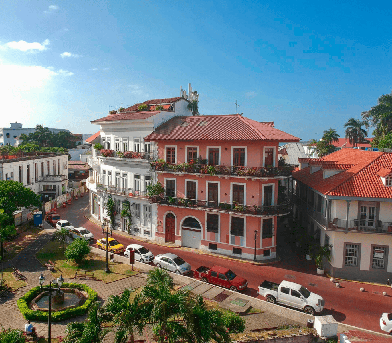 Corner view of Casco Viejo buildings with red rooftops and colonial balconies by Plaza Bolívar