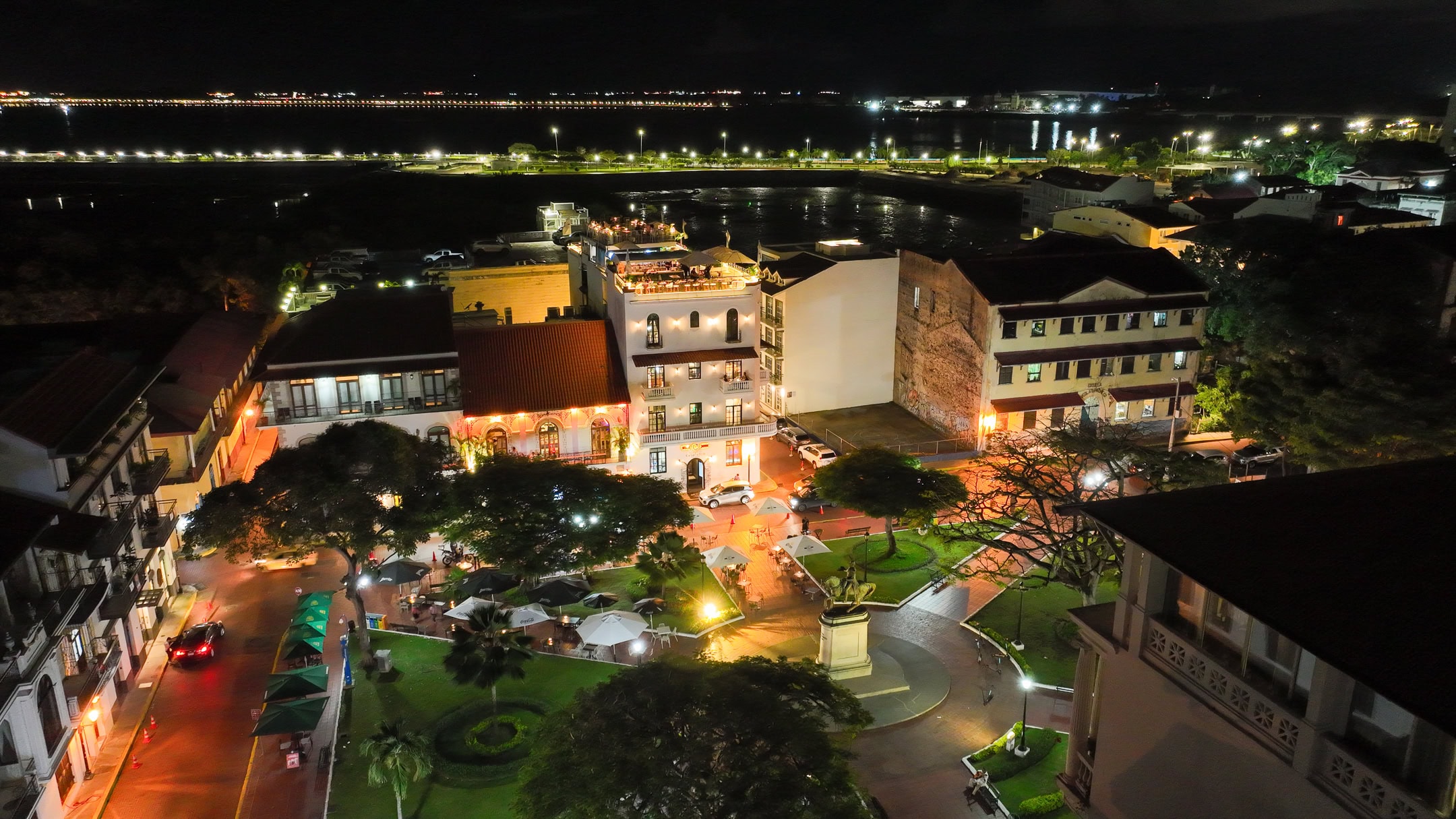 Plaza Herrera in Casco Viejo lit up at night with glowing cafes and park paths