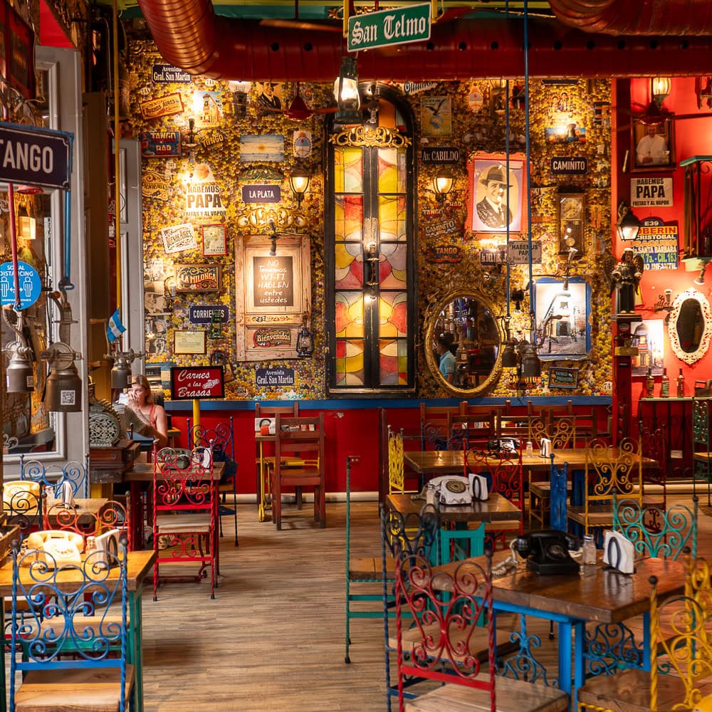 Colorful tango-themed restaurant interior with vintage décor and eclectic lighting