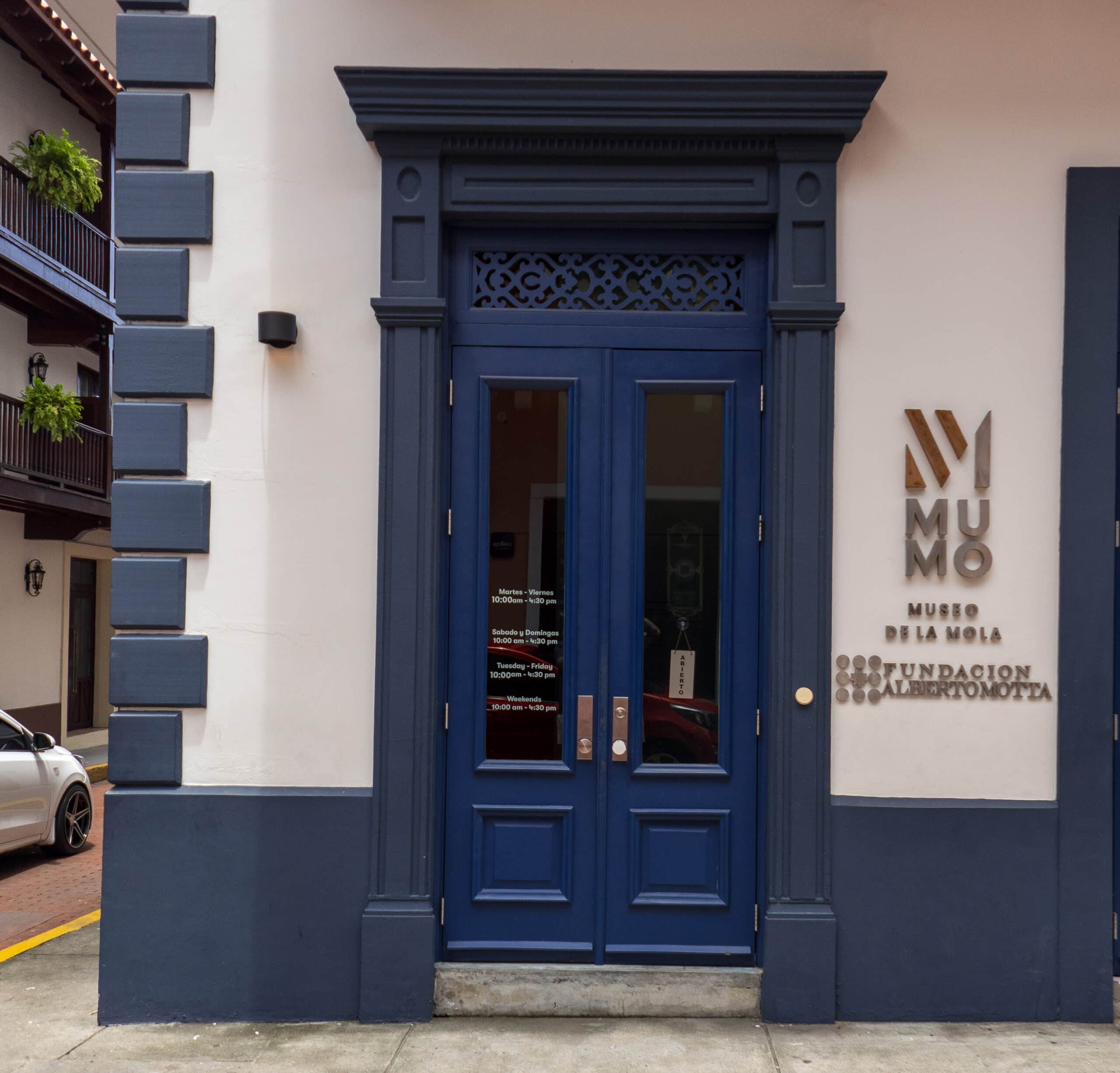 Entrance of MUMO Museum with navy blue double doors and modern signage in Casco Viejo, Panama