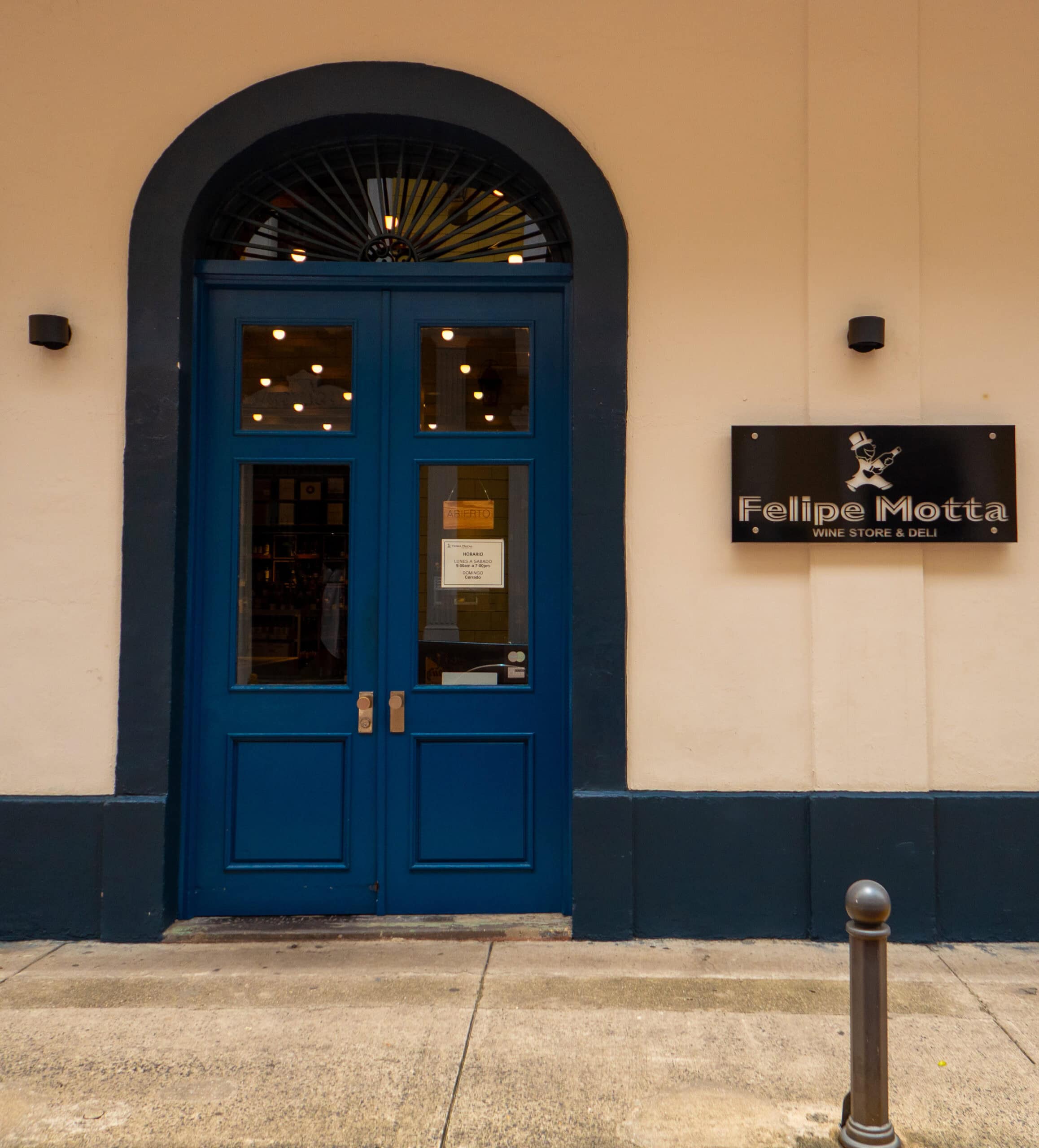 Entrance of Felipe Motta Wine Store & Deli with deep blue double doors in Casco Viejo, Panama