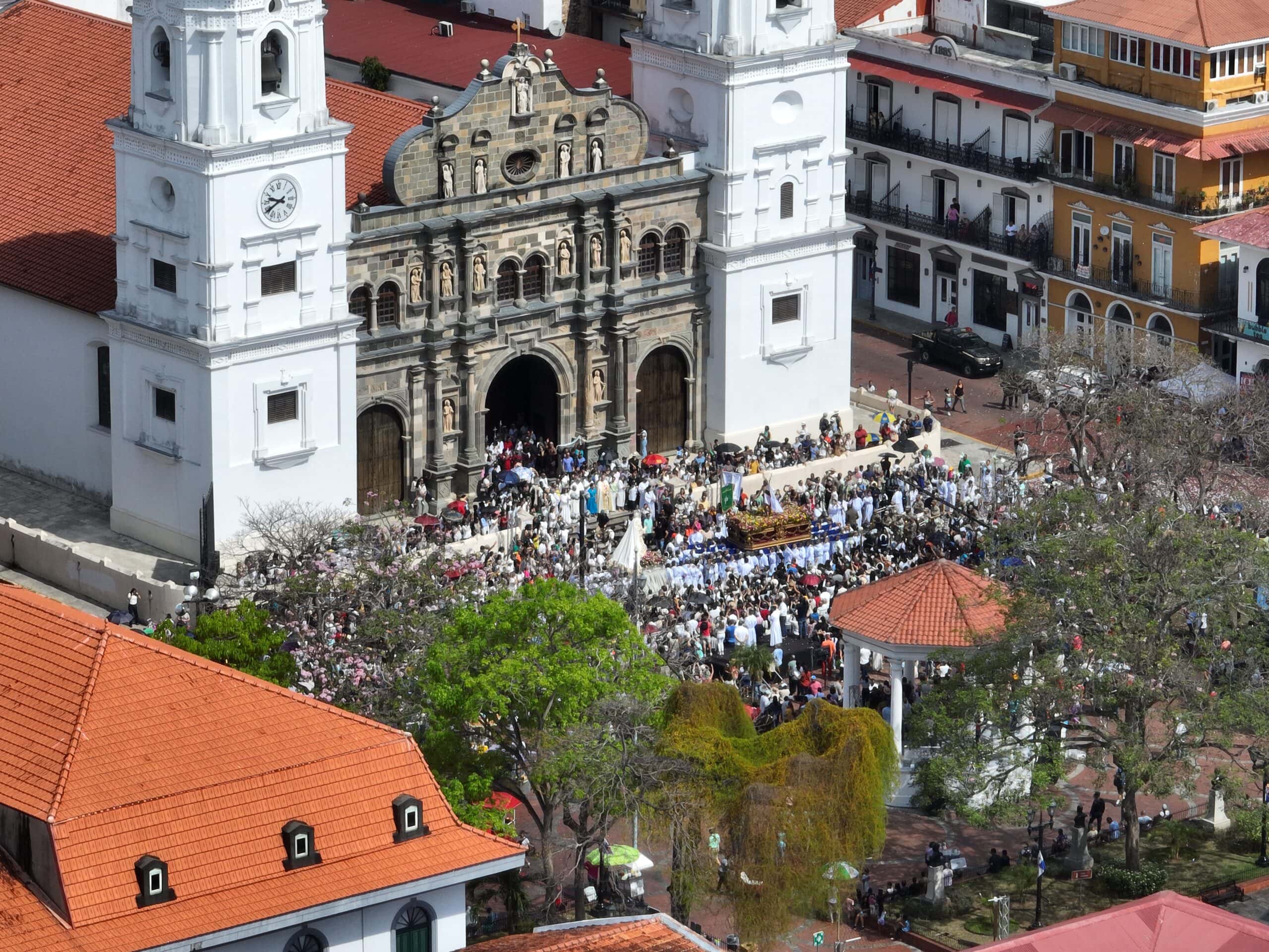 Aerial view of Metropolitan Cathedral in Casco Viejo, Panama, with a large crowd gathered in front