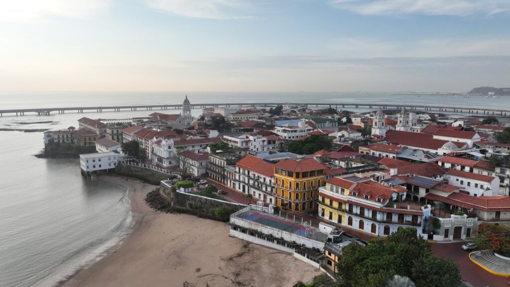 Aerial view of Casco Viejo Panama at sunrise with beachfront and historic rooftops