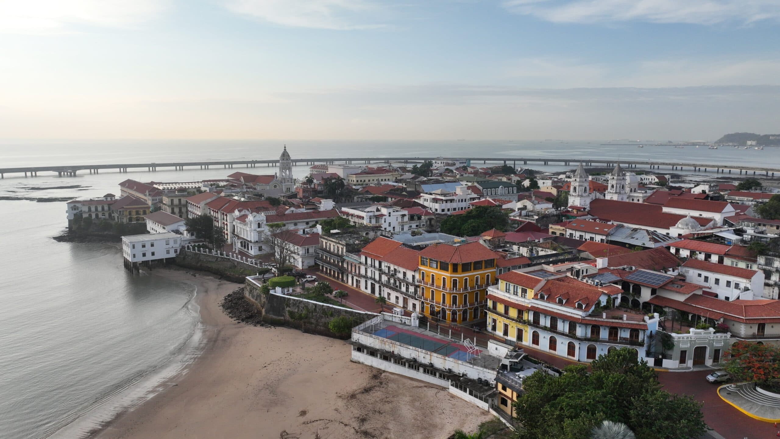 Aerial view of Casco Viejo Panama at sunrise with beachfront and historic rooftops