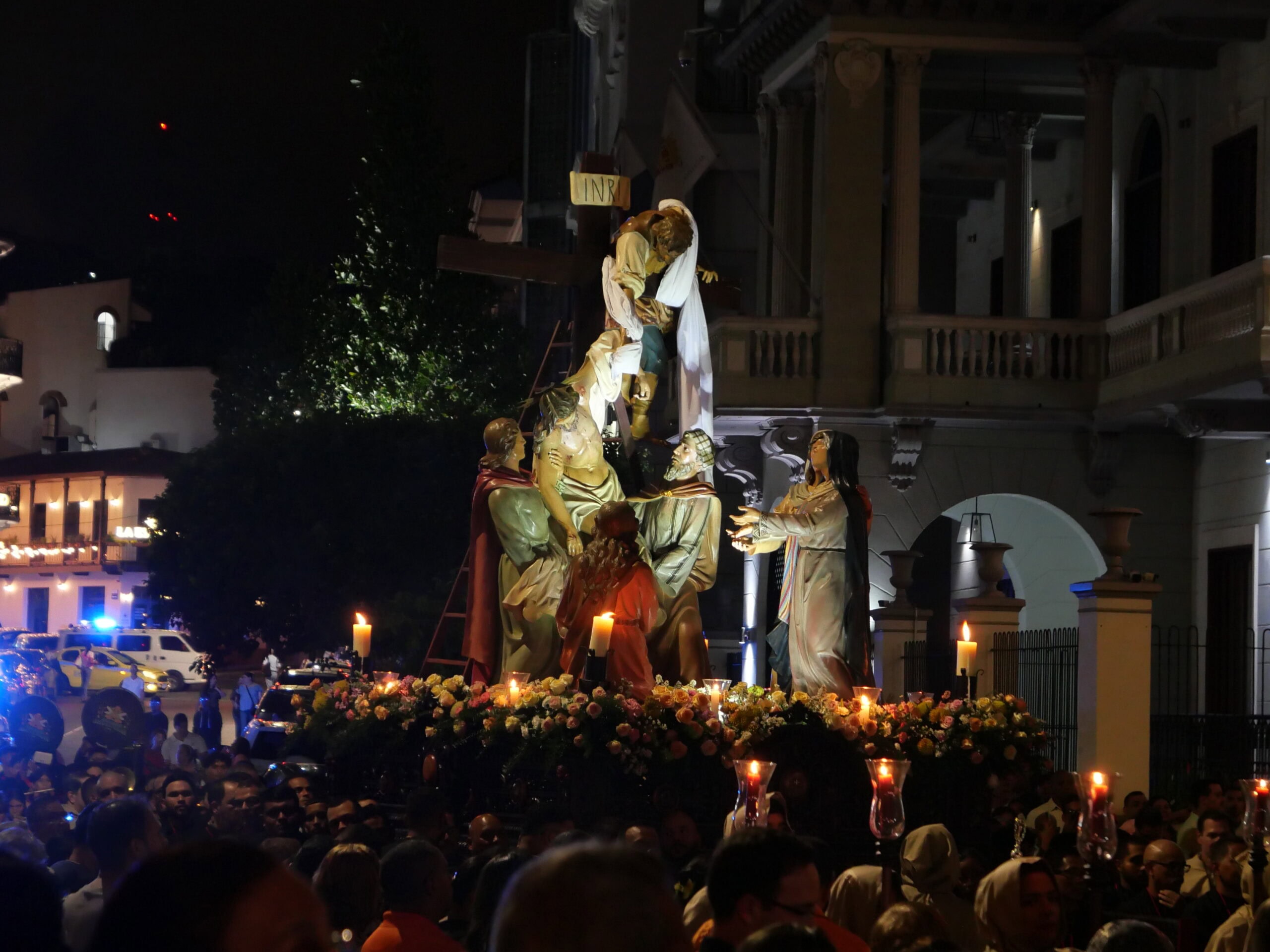 Holy Week procession in Casco Viejo featuring the Descent from the Cross statue float surrounded by candlelight and crowds