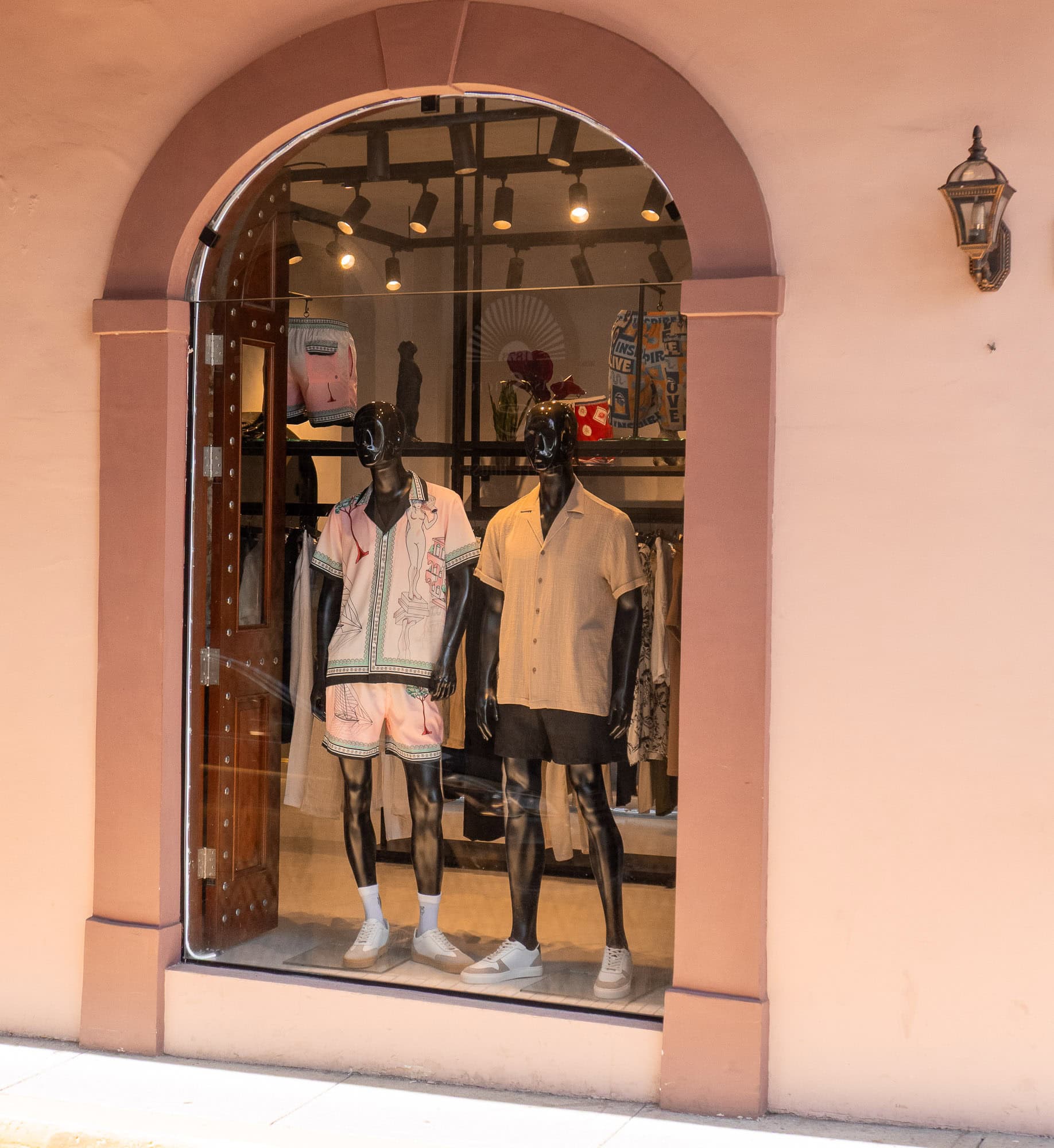 Mannequins in pastel and neutral outfits displayed in a boutique storefront window in Casco Viejo, Panama