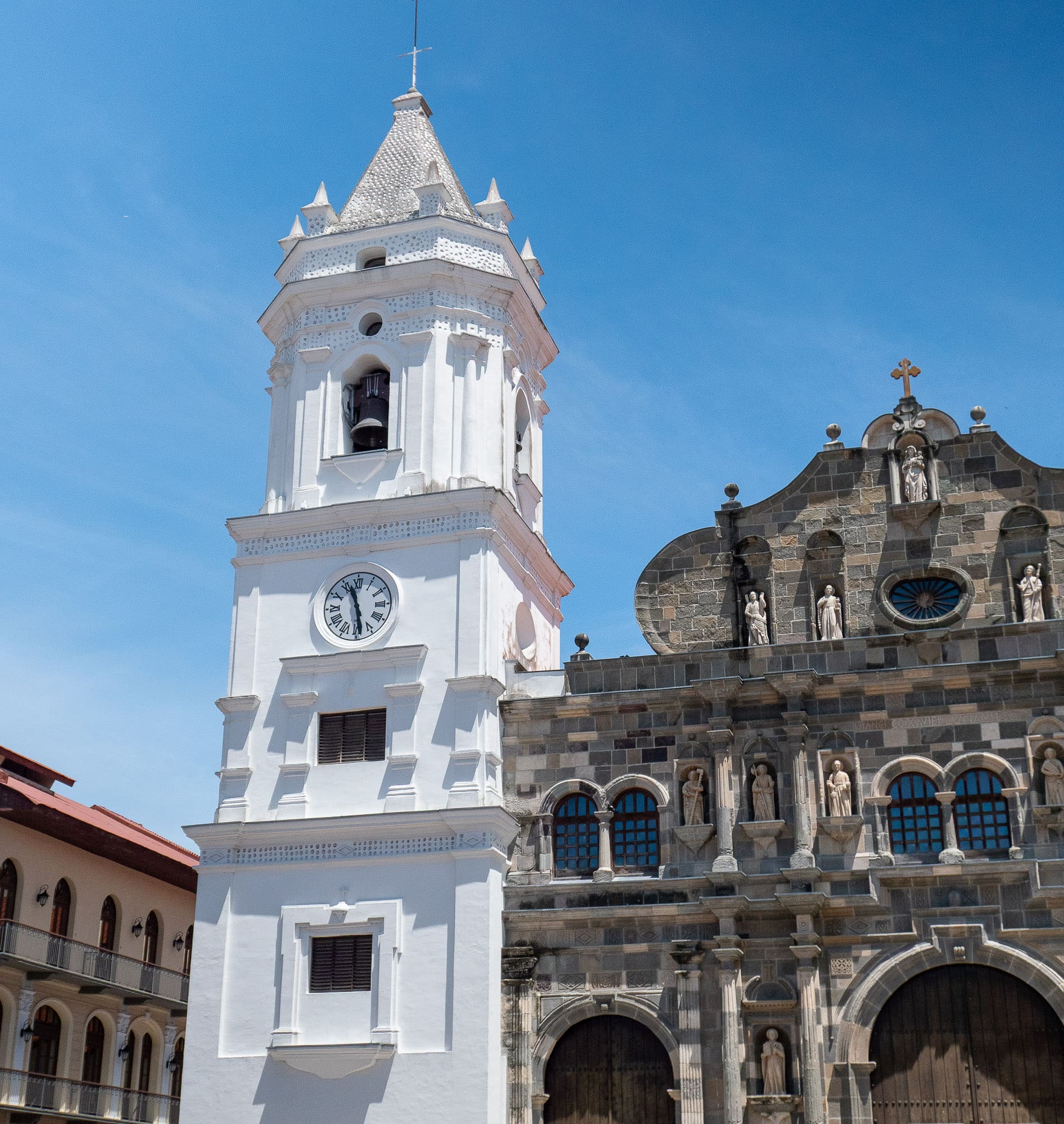 Metropolitan Cathedral of Panama in Casco Viejo with its white bell tower and historic stone façade under a blue sky