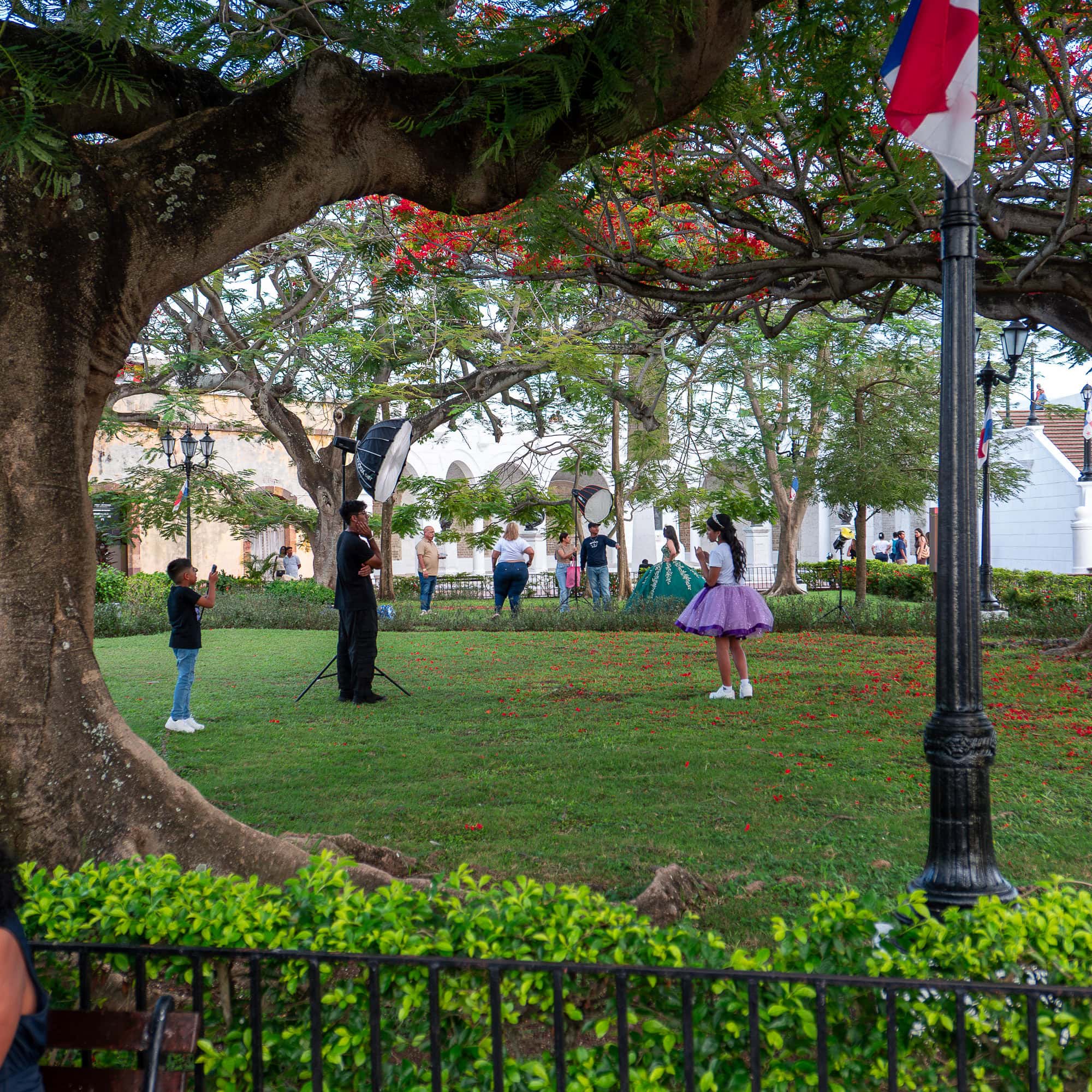 Young girl poses for a photo shoot under the trees in Plaza de Francia, Casco Viejo, Panama.