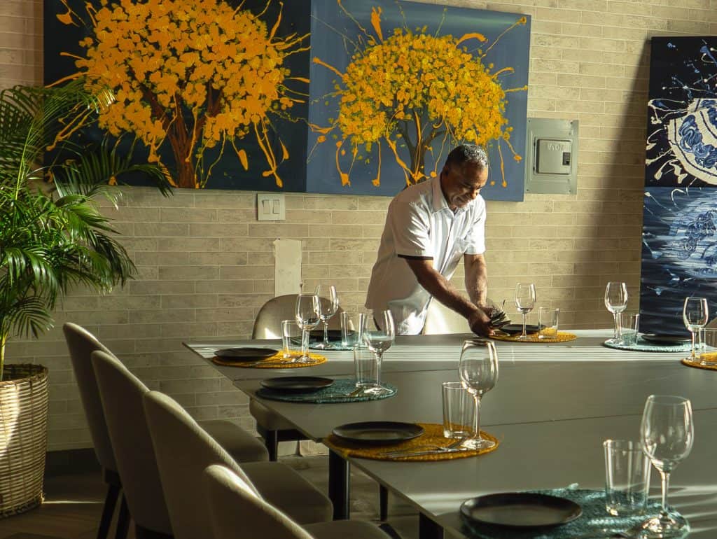 Server setting a dining table at Aya La Vida restaurant in Casco Viejo Panama