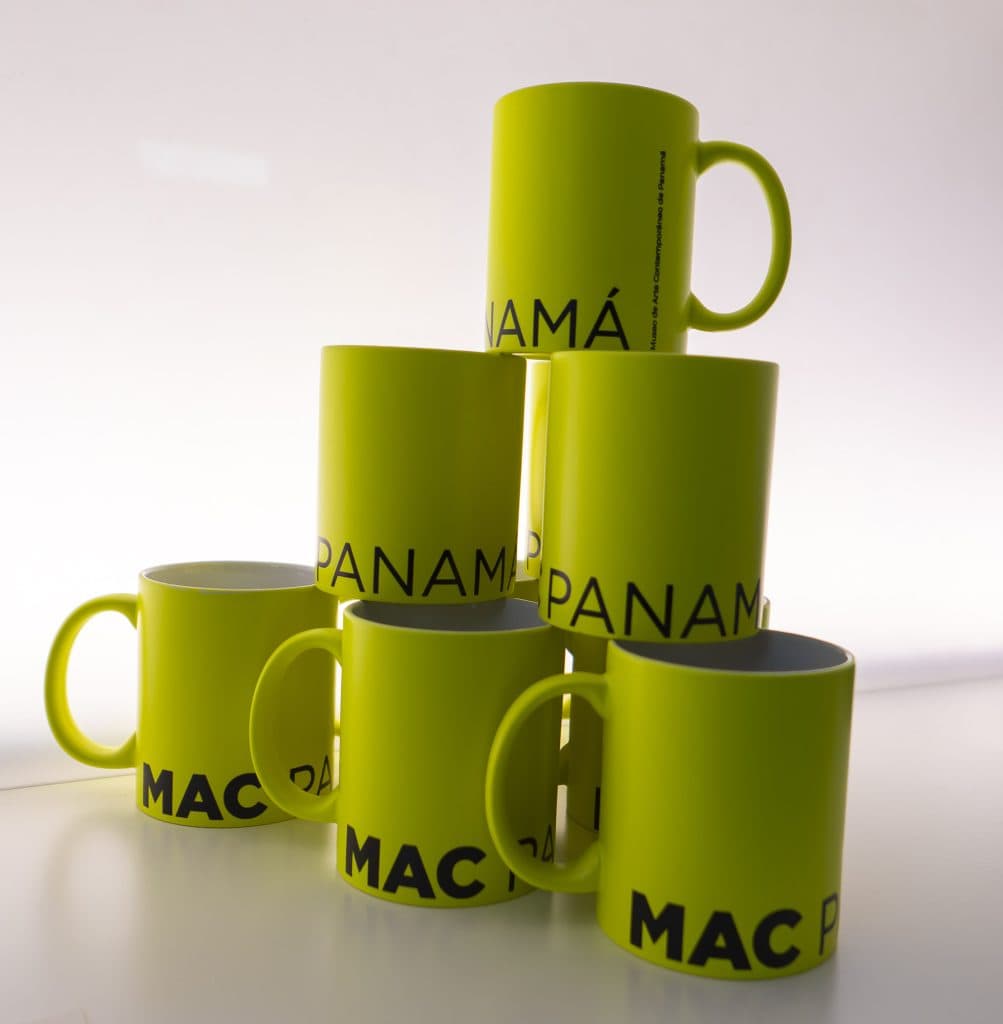 Stack of bright yellow MAC Panamá souvenir mugs at the Casco Antiguo museum gift corner