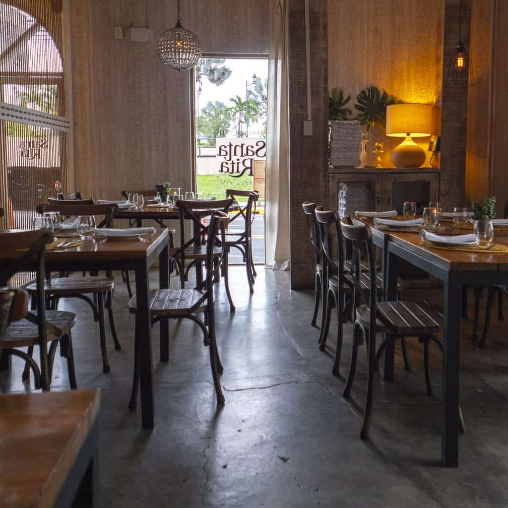 Santa Rita Casco Viejo dining room with rustic wooden tables and street view