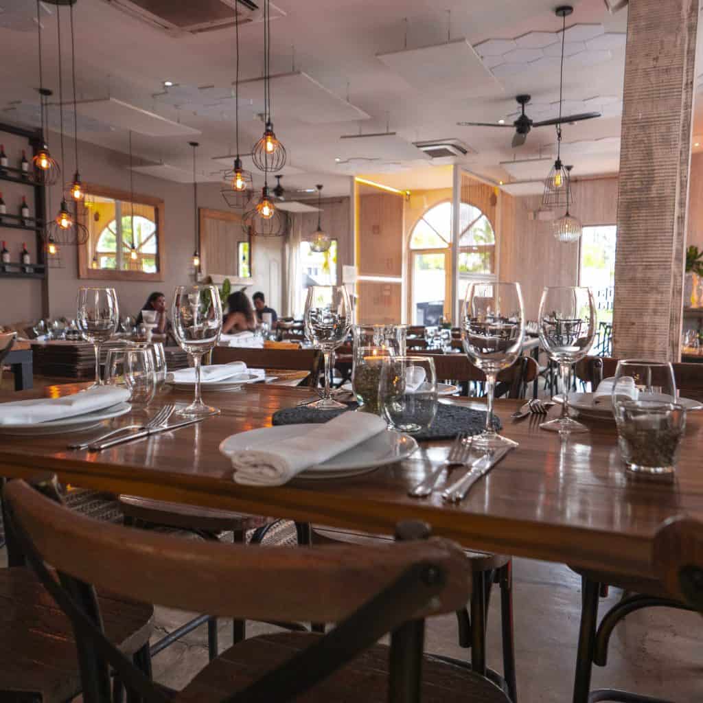 Santa Rita Casco Viejo main dining room with set tables and warm lighting