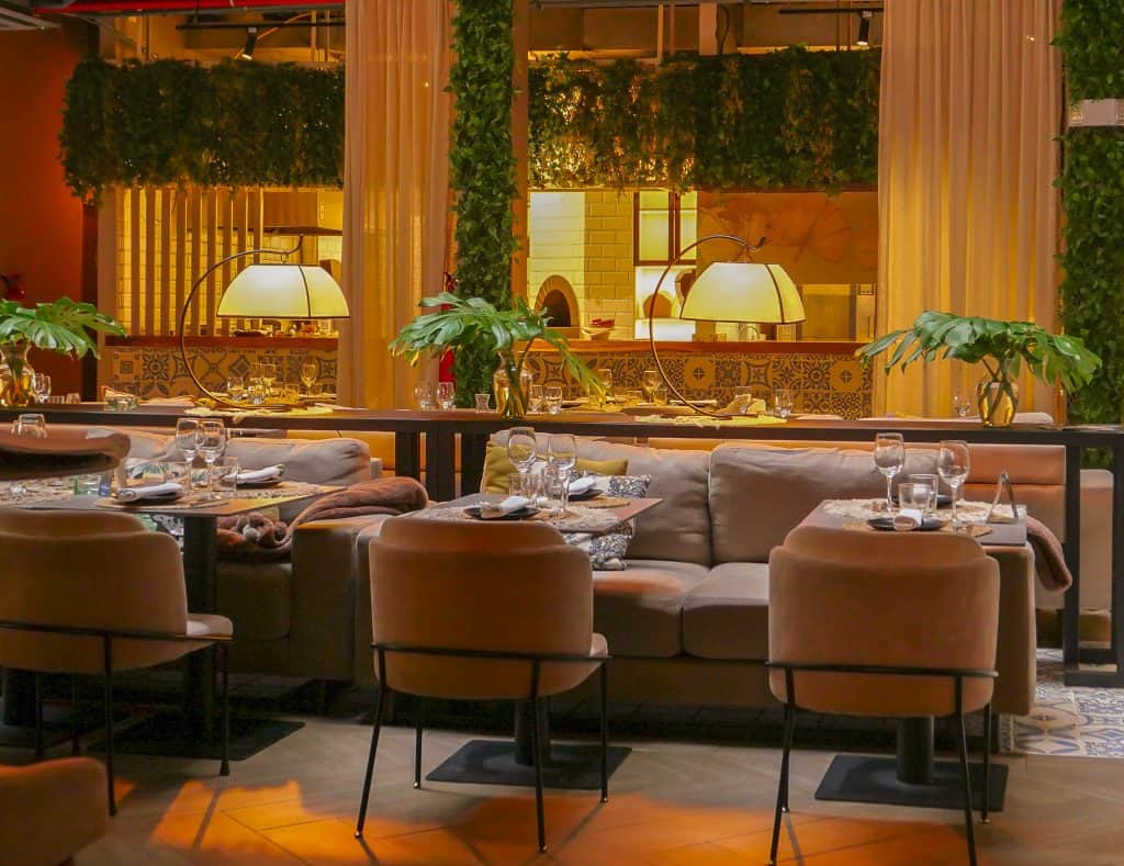 Aya La Vida Casco Viejo lounge dining area with warm lighting and elegant table settings