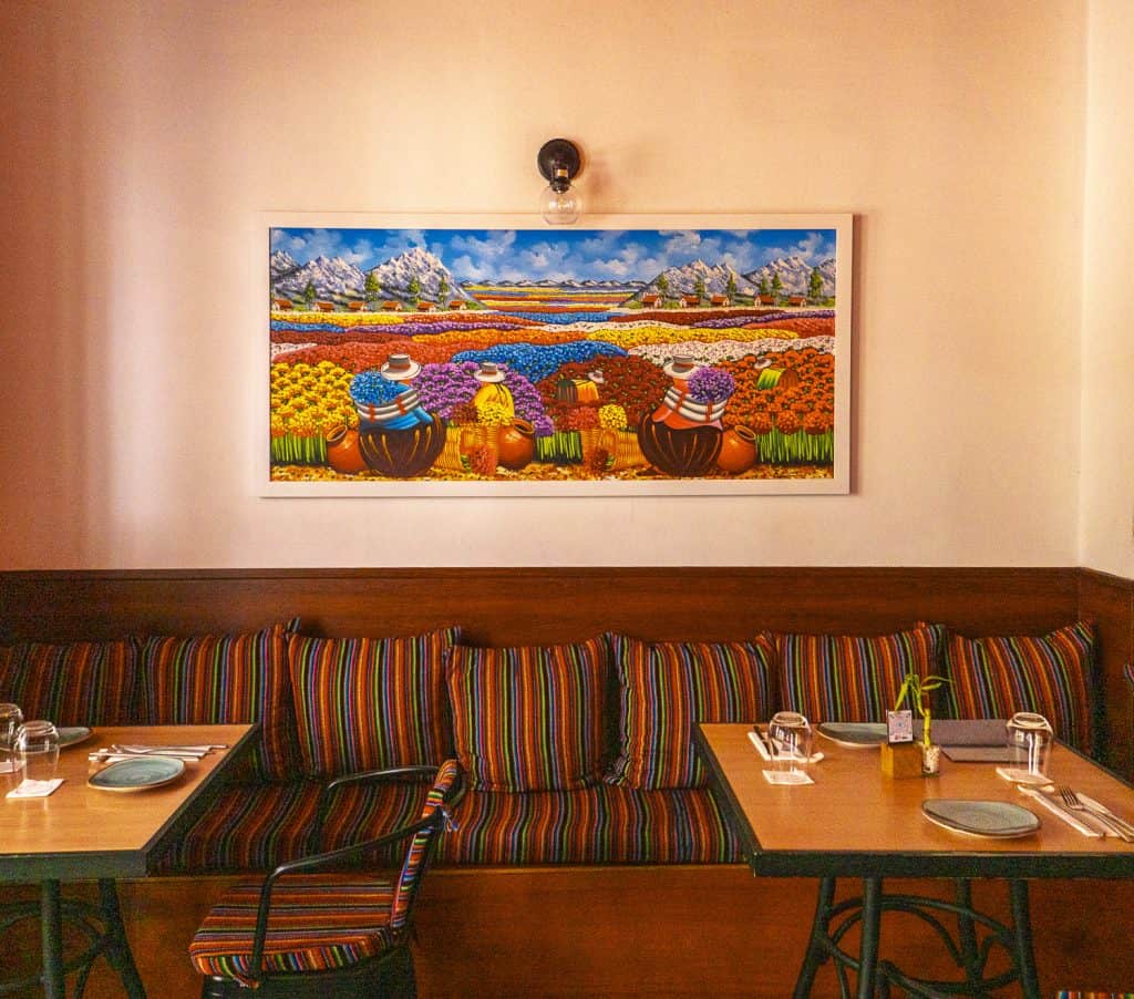 Vibrant artwork of colorful flower fields and mountains, highlighting Panama’s scenic beauty and cultural richness.