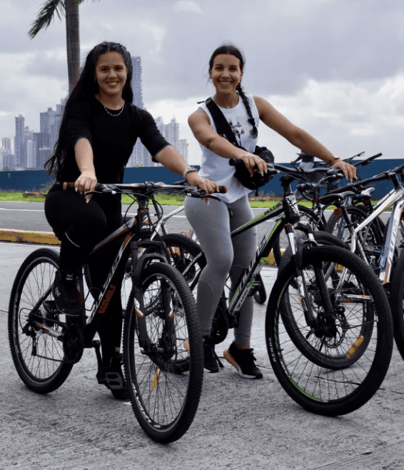 Two women biking along Panama City’s waterfront, popular bicycling activity connecting Casco Viejo with the Cinta Costera.