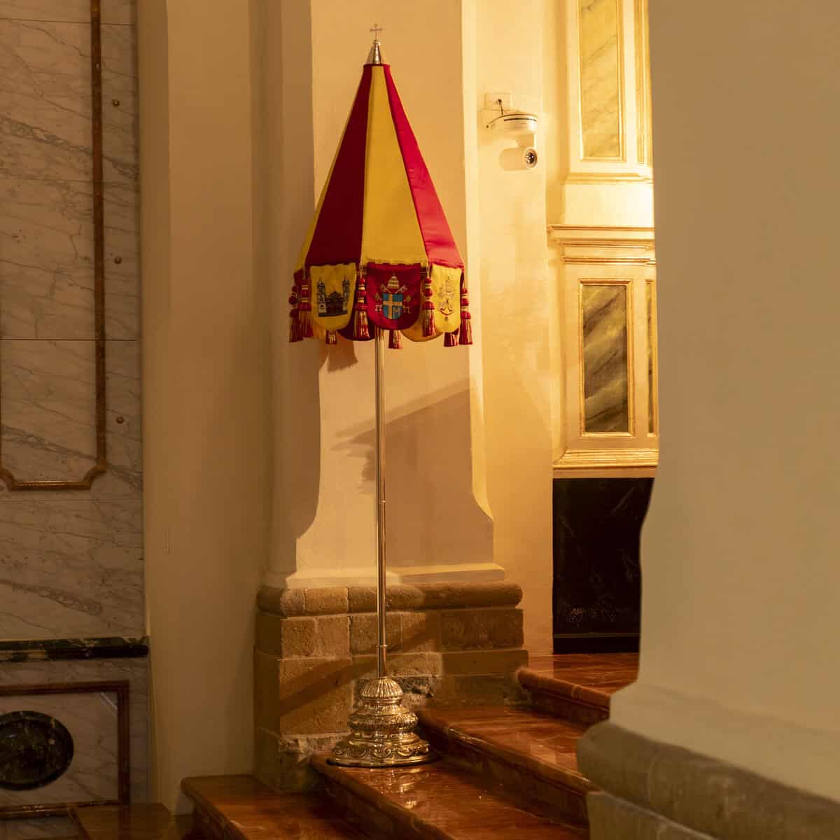 Conopeo, the red and gold papal umbrella, displayed inside the Metropolitan Cathedral of Panama in Casco Viejo.