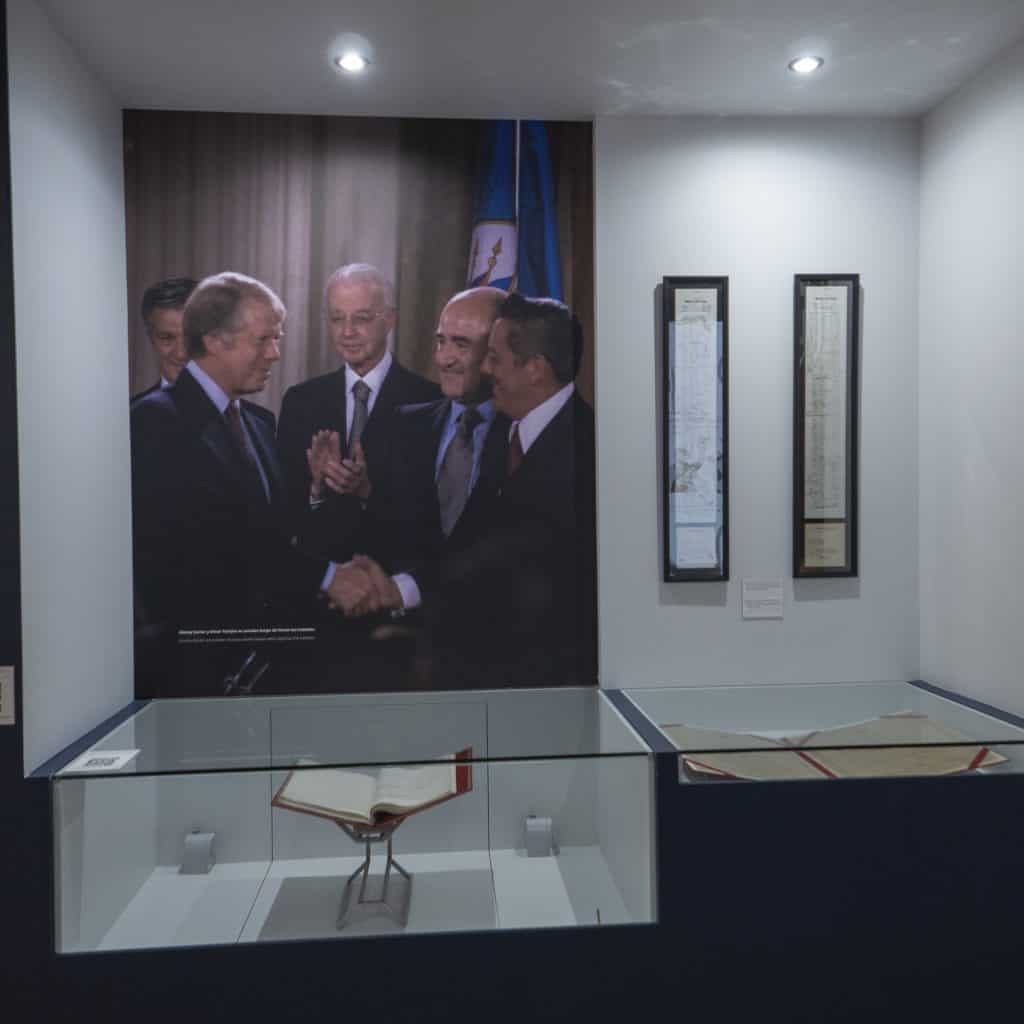 Exhibit showing the Torrijos–Carter Treaties signing at the Panama Canal Museum, featuring historic photo of leaders and the original treaty documents on display.