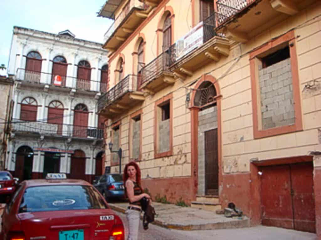 Historic Casa Garay in Casco Viejo Panama with resident standing outside before restoration