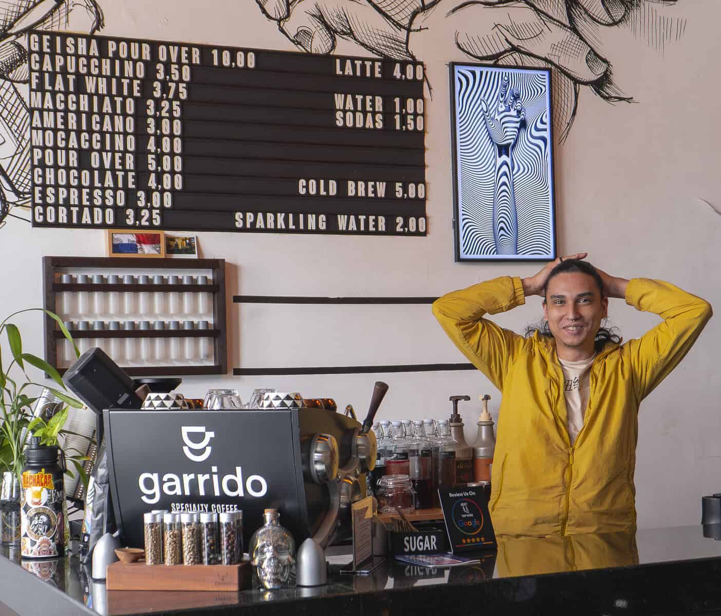 Antonio the barista at KAIL Tattoo Studio Coffee Bar in Casco Viejo Panama preparing specialty Garrido coffee