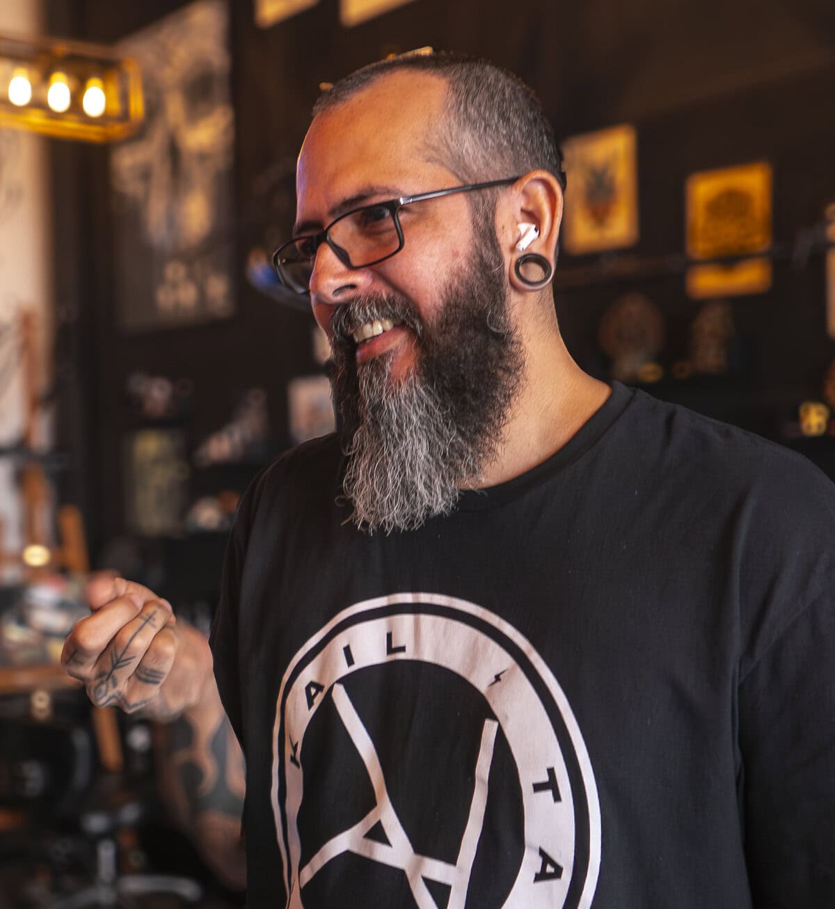 Kail smiling inside his tattoo studio and coffee bar in Casco Viejo Panama, reflecting warmth and authenticity.