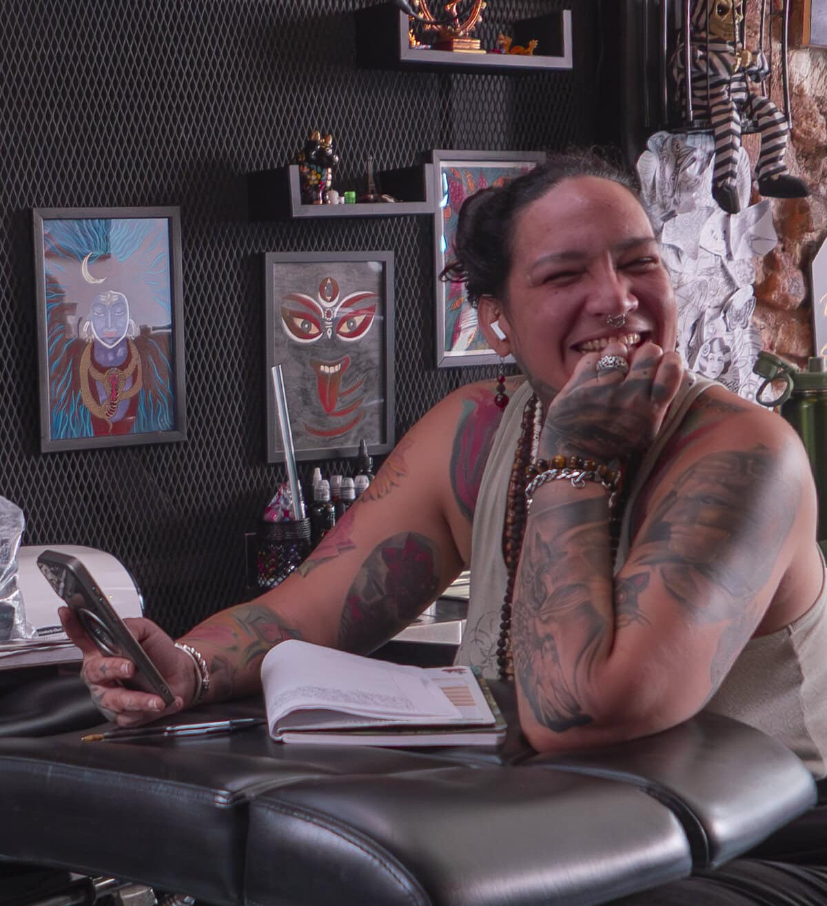 Tattoo artist laughing inside Kail Tattoo Studio in Casco Viejo Panama, capturing the creative and welcoming spirit of the space.
