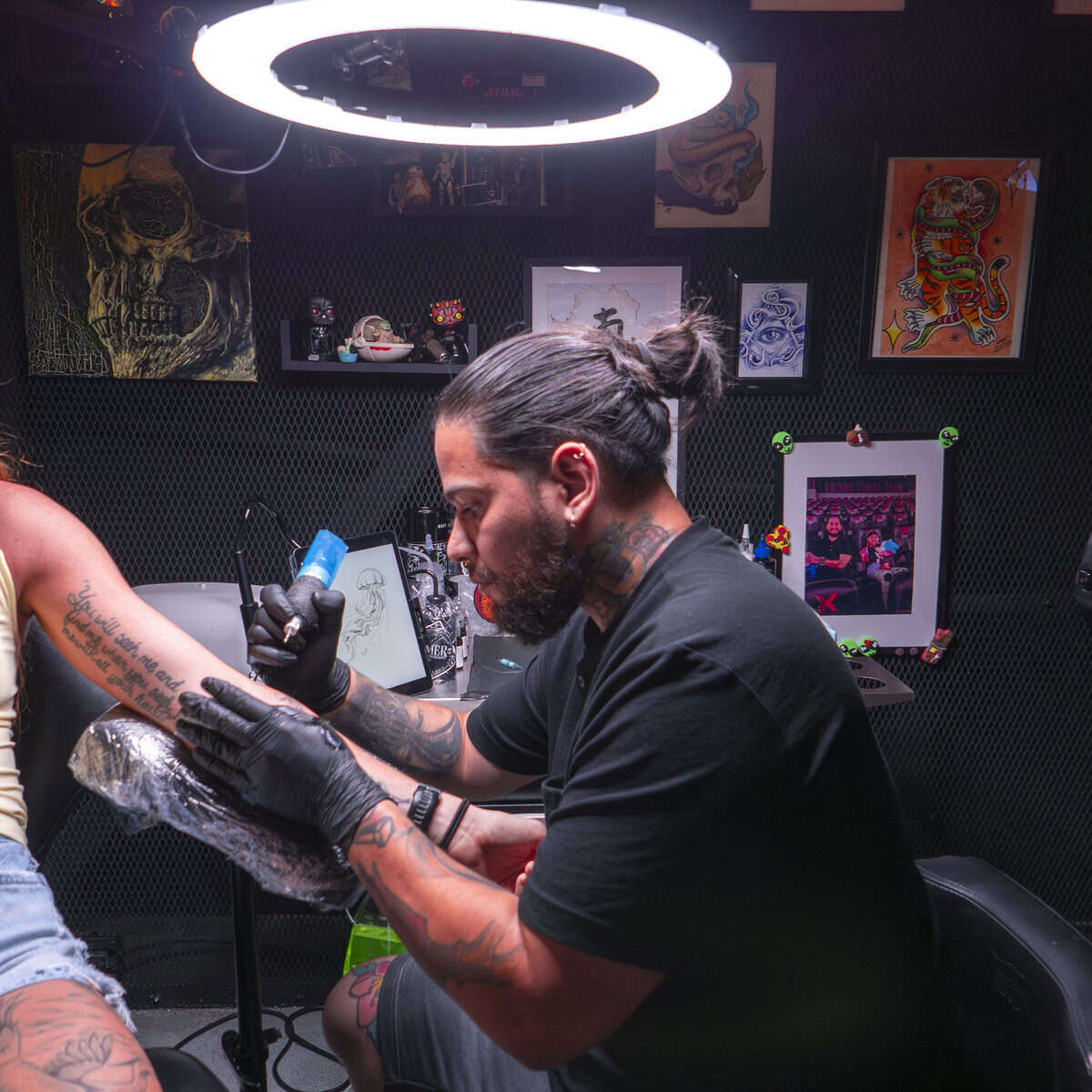 Tattoo artist Emer working at KAIL Tattoo Studio Casco Viejo Panama under studio light creating fine line design