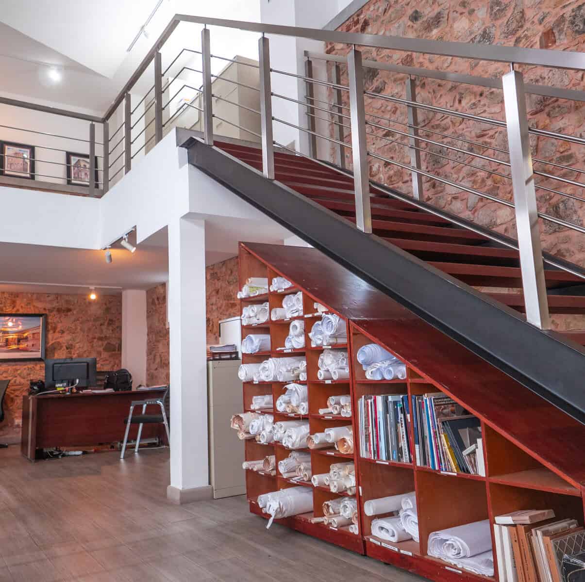 Interior office of Compañía Inmobiliaria San Felipe in Casco Viejo Panama showing restored brick walls and architectural plans