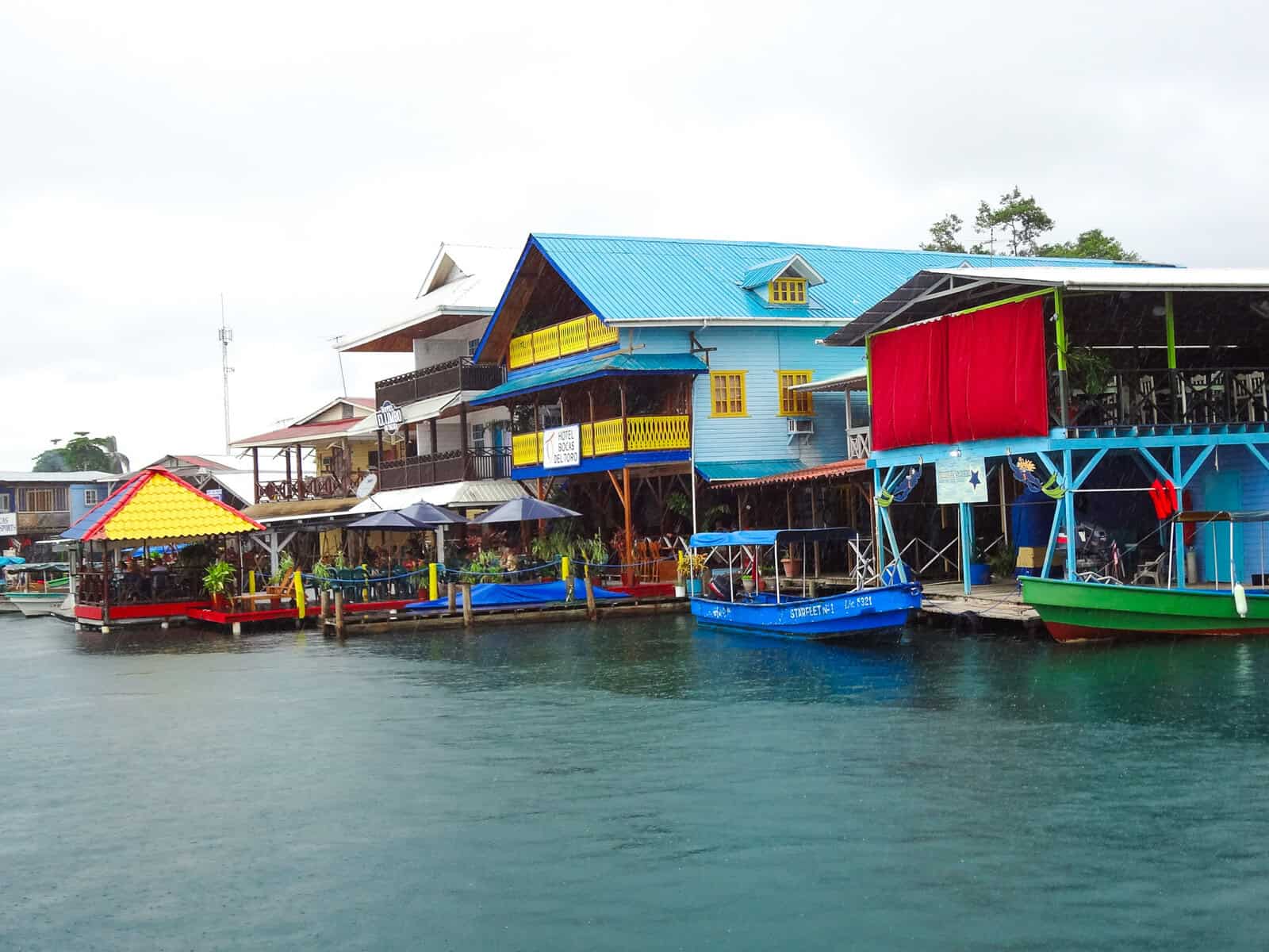 Colorful waterfront buildings in Bocas del Toro town, Panama, with boats docked along the canal