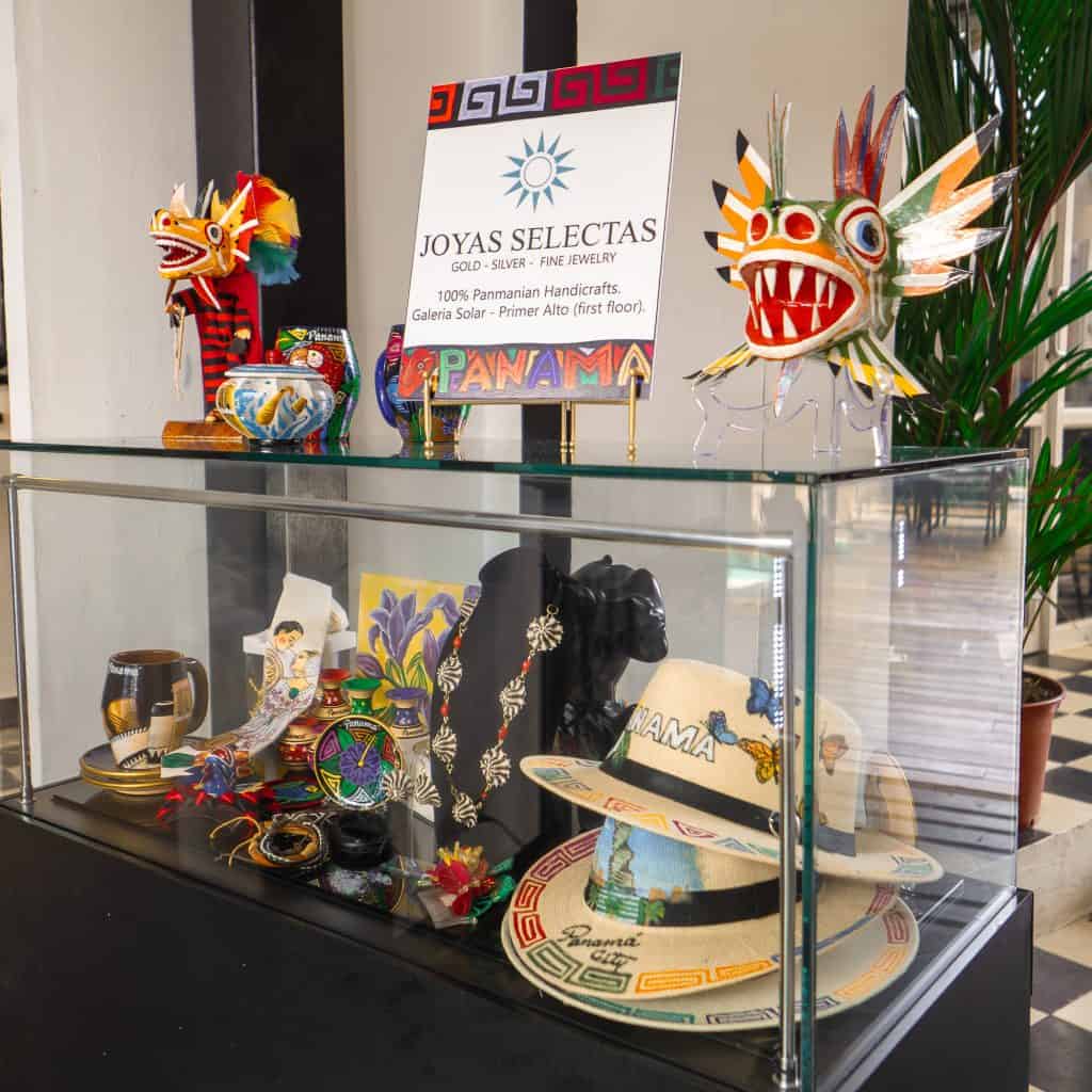 Glass display case at Joyas Selectas in Casco Viejo featuring Panamanian hats, jewelry, and artisan crafts.
