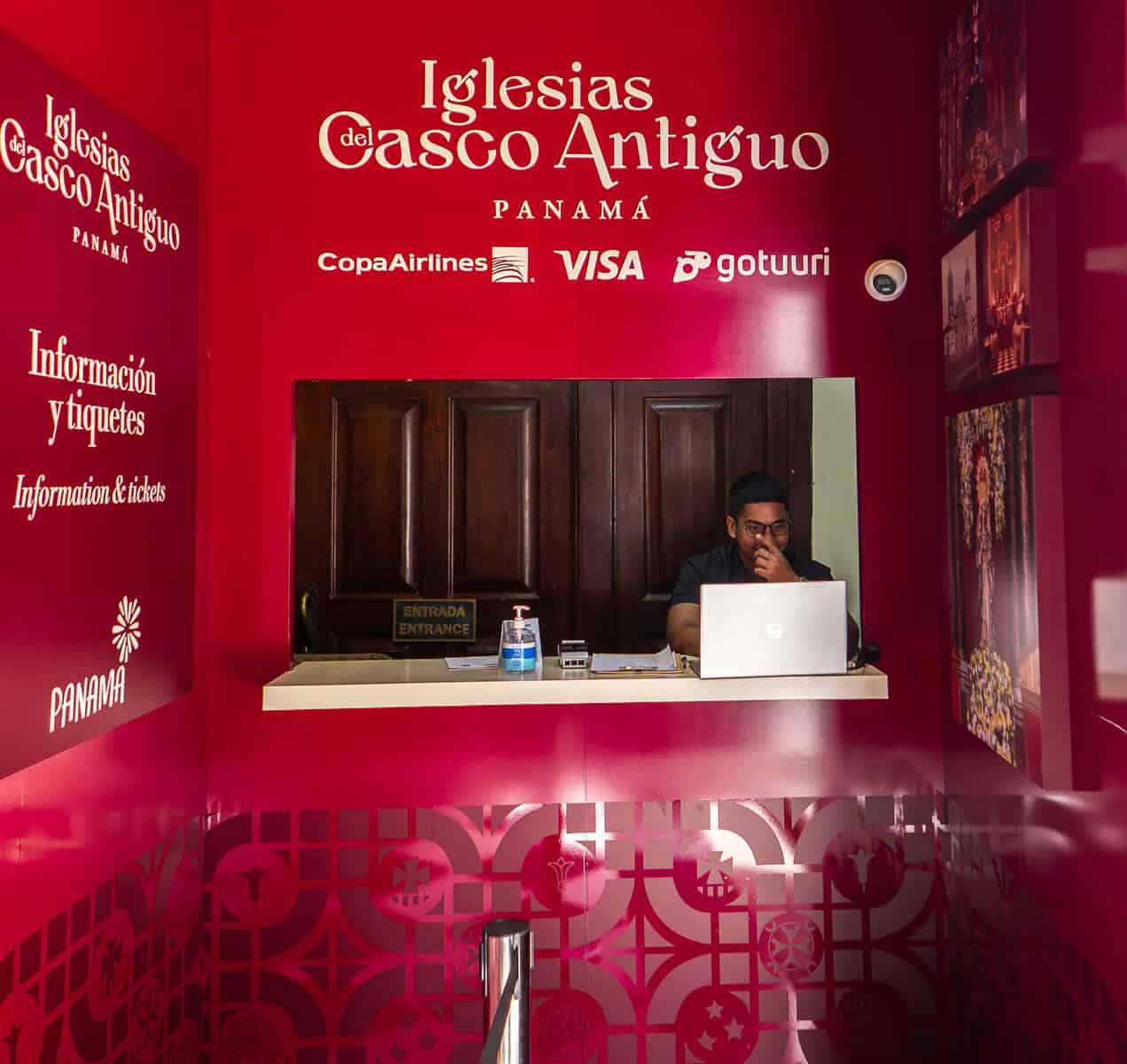 Ticket counter for Iglesias del Casco Antiguo with a staff member seated behind a small service window.