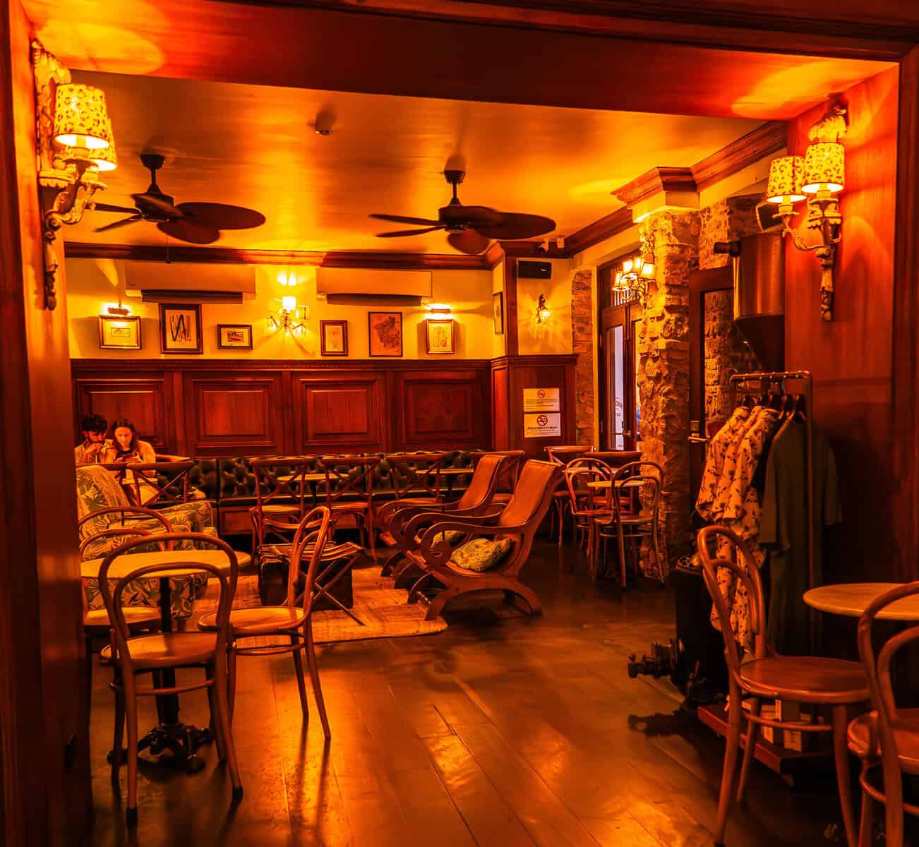Interior seating area inside Mandinga Rum Bar in Casco Viejo, Panama, showing lounge chairs and tables set for tastings
