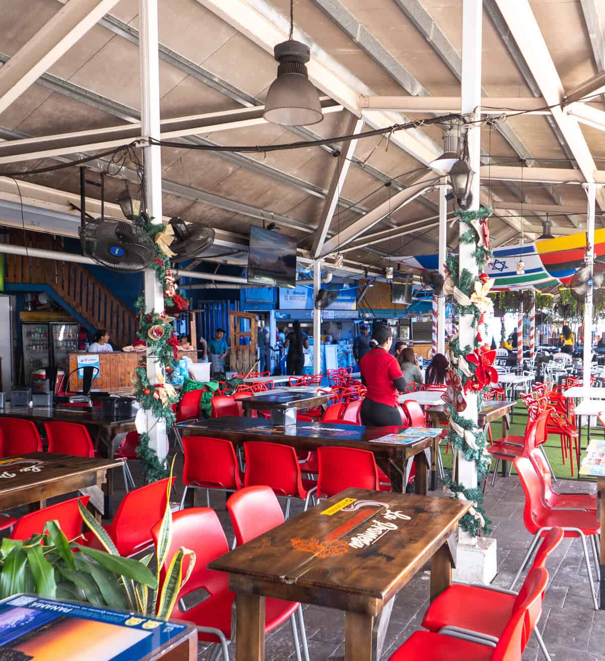 Seafood vendors prepare and cut fish at individual stalls the Casco Viejo Fish Market in Panama City.