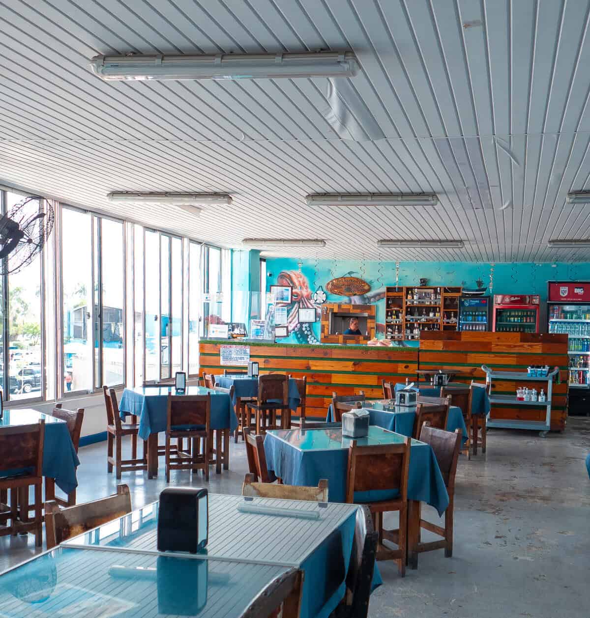 Dining tables inside the Casco Viejo Fish Market where locals sit and eat freshly prepared seafood in Panama City.