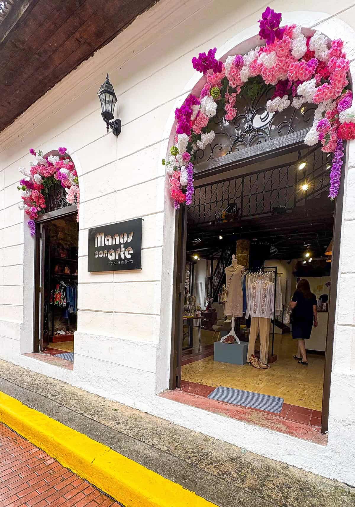 Manos con Arte gallery and studio on First Street in Casco Viejo, Panama with large arched entrance and upstairs artisan workshop