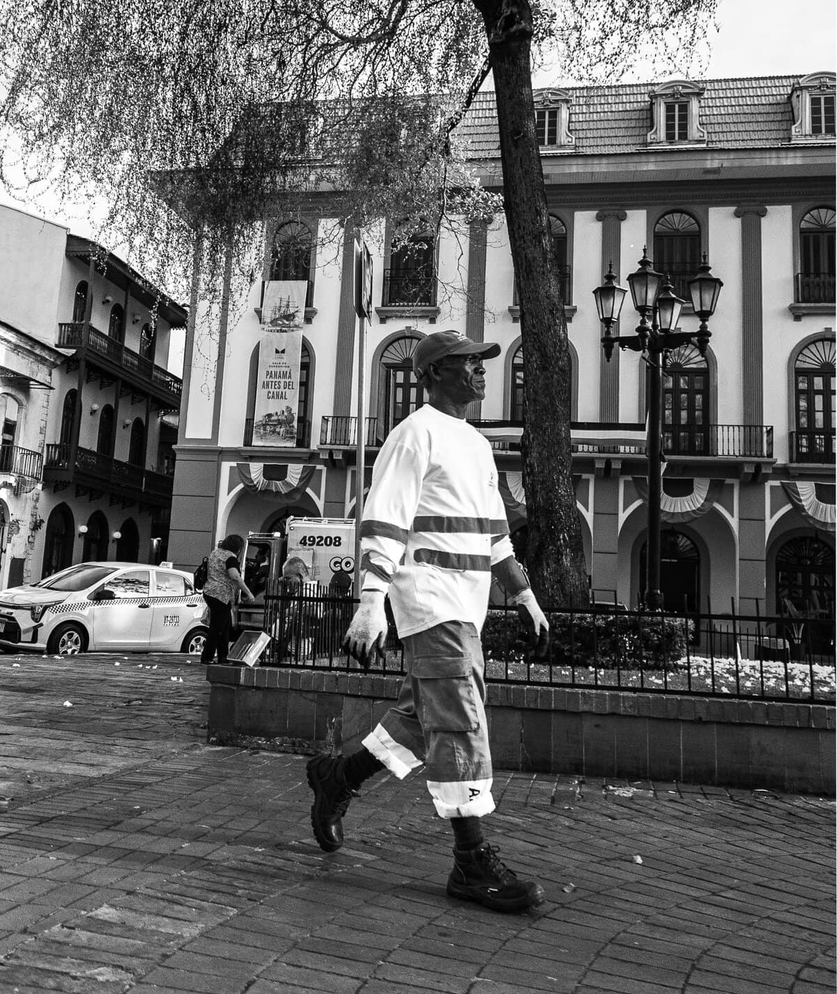 Municipal worker walking through Plaza Bolívar in Casco Viejo Panama