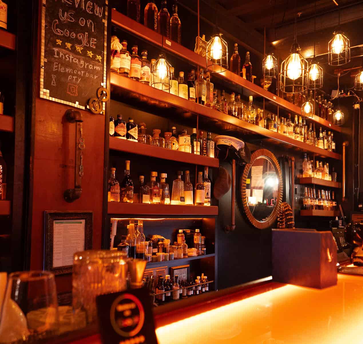 Back bar interior at Element Bar Casco Viejo with illuminated shelves and spirits display