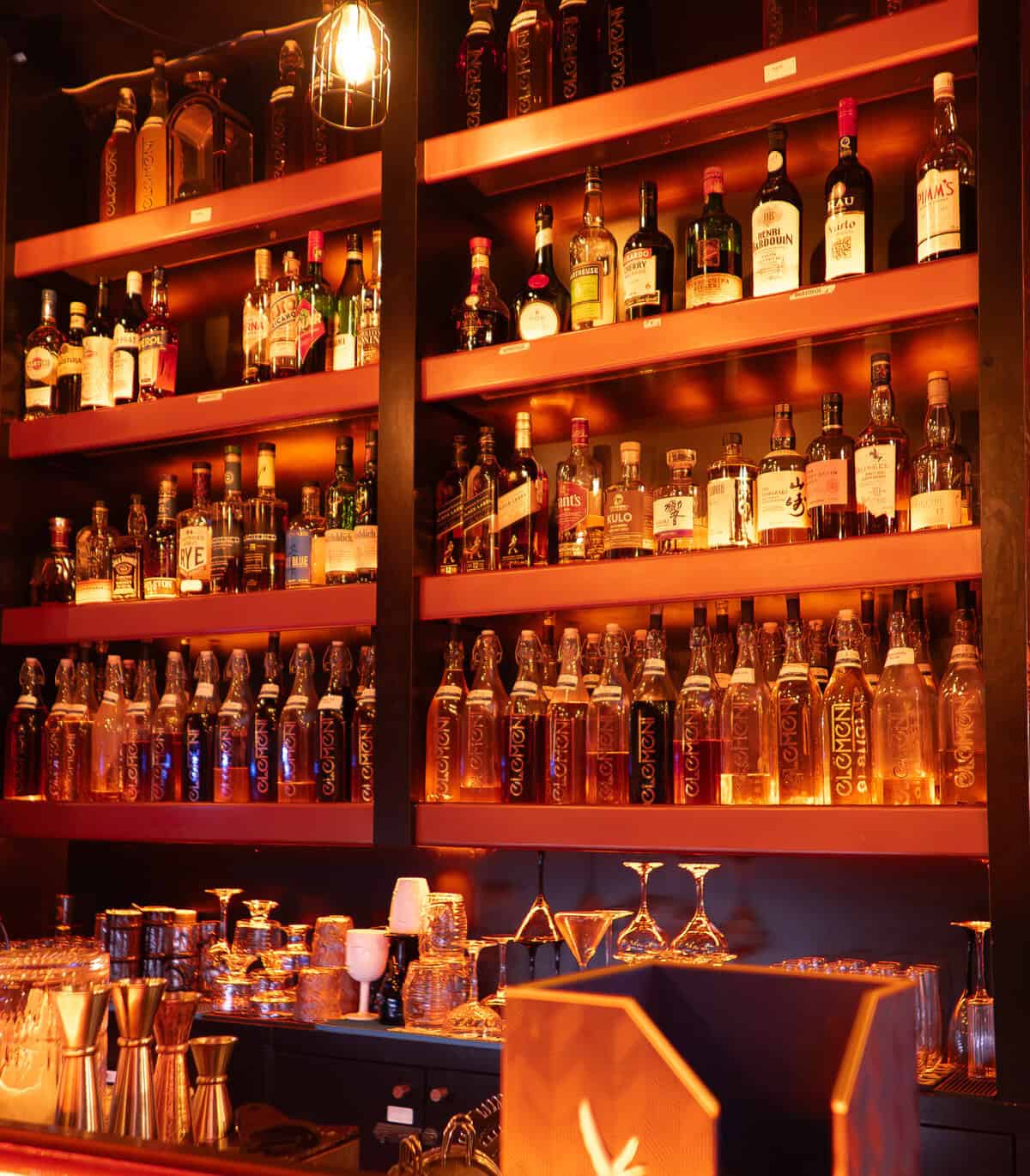 Back bar shelves at Element Bar Casco Viejo with illuminated bottles and glassware
