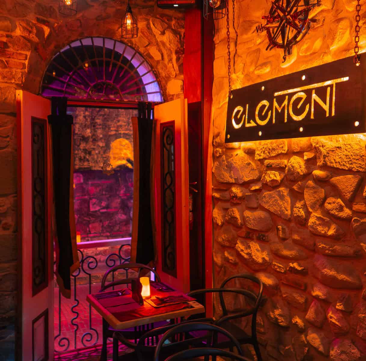 Restaurant dining area at Element Bar Casco Viejo with stone walls and warm lighting