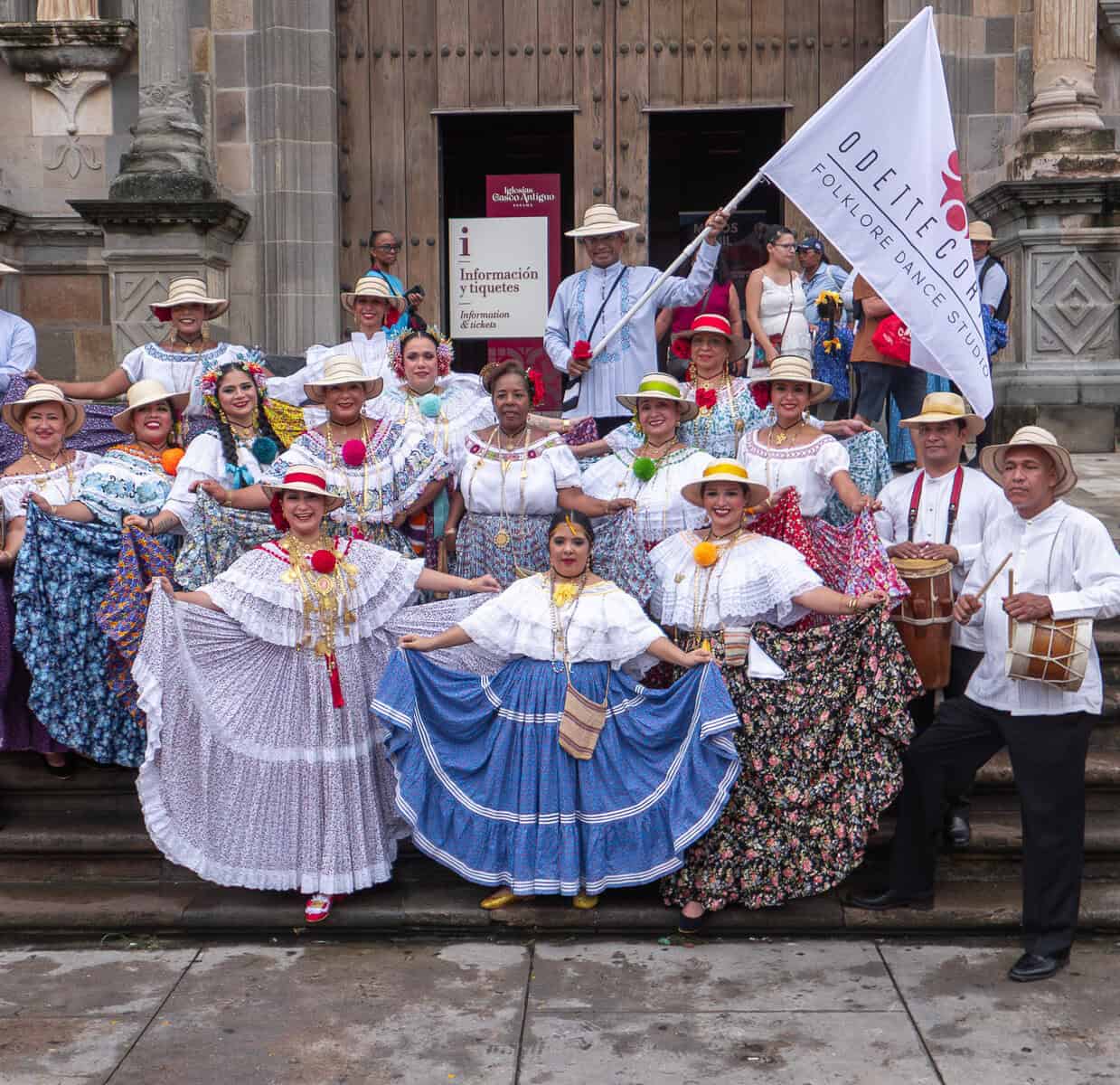 Panamanian folkloric dancers in traditional pollera dresses performing outside the Metropolitan Cathedral in Casco Viejo, Panama City.