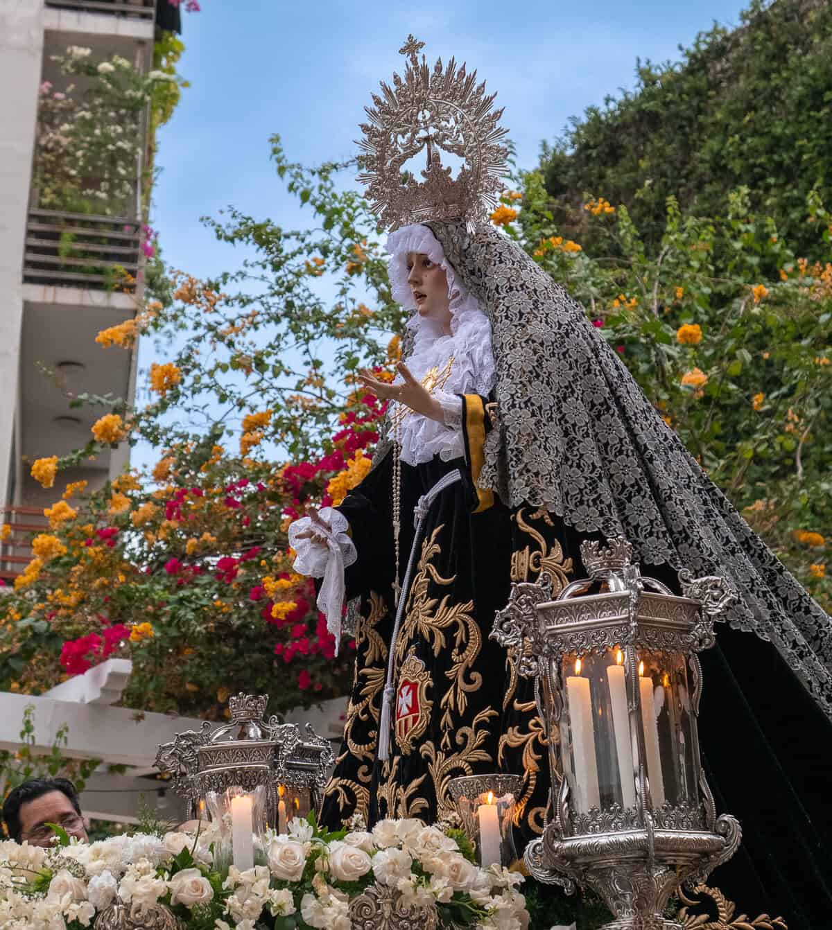 Marian statue carried during Holy Week procession in Casco Viejo Panama with silver lanterns and floral platform