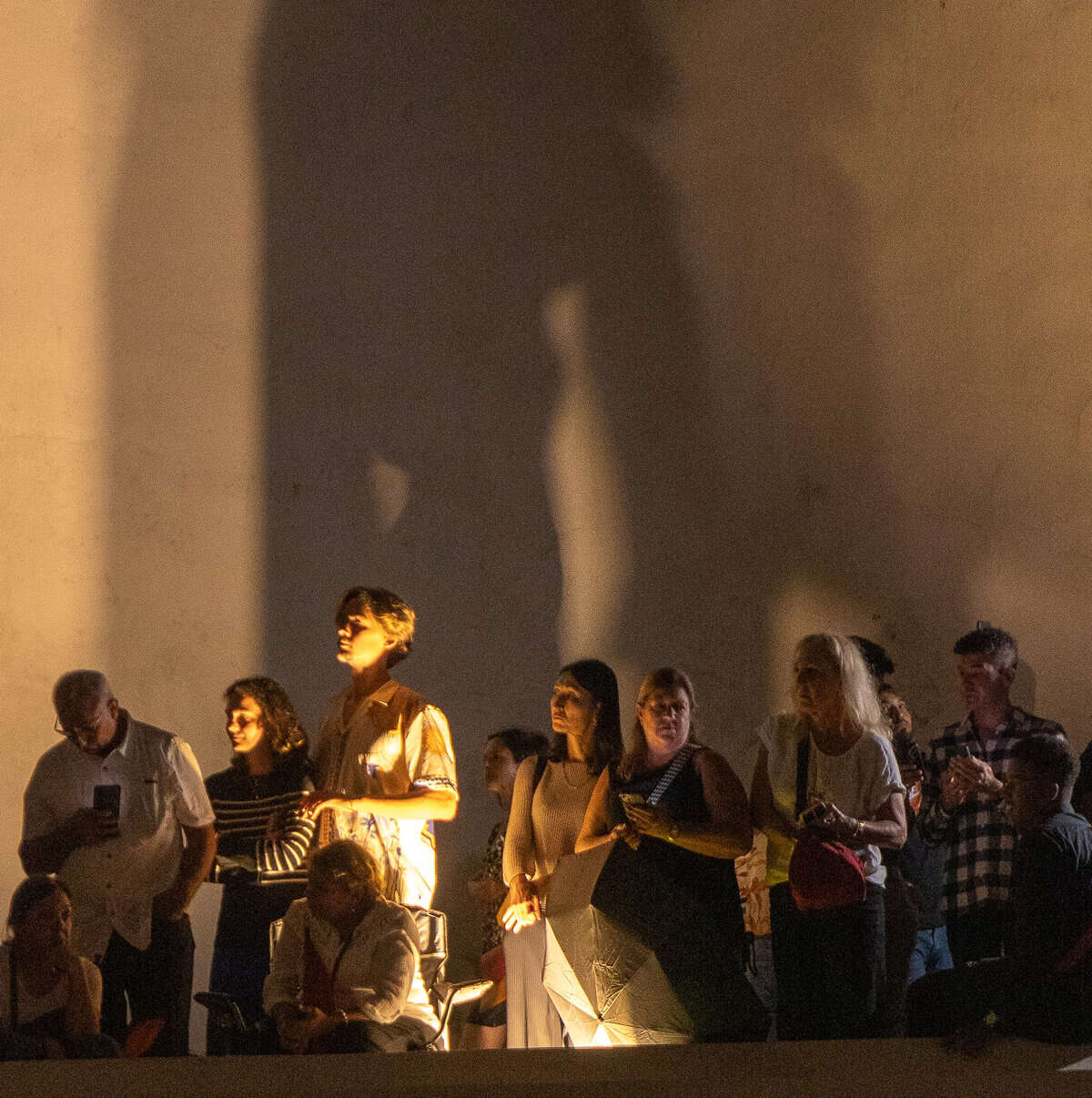 Candlelit crowd and Marian shadow during Holy Week procession in Casco Viejo Panama at night