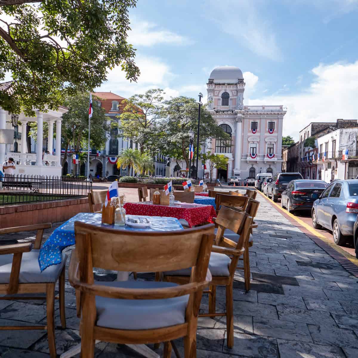 Alfresco dining tables set outside in Plaza de la Catedral in Casco Viejo, Panama City, with the Metropolitan Cathedral and colonial architecture in the background.