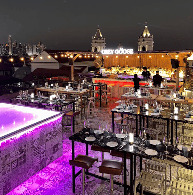 Rooftop bar at Hotel San Felipe in Casco Viejo Panama with evening dining, city skyline views, and illuminated terrace seating