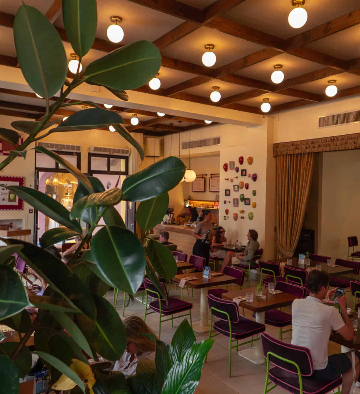 Dining room at Alura restaurant in Tántalo Hotel Casco Viejo, Panama with high ceilings and indoor seating