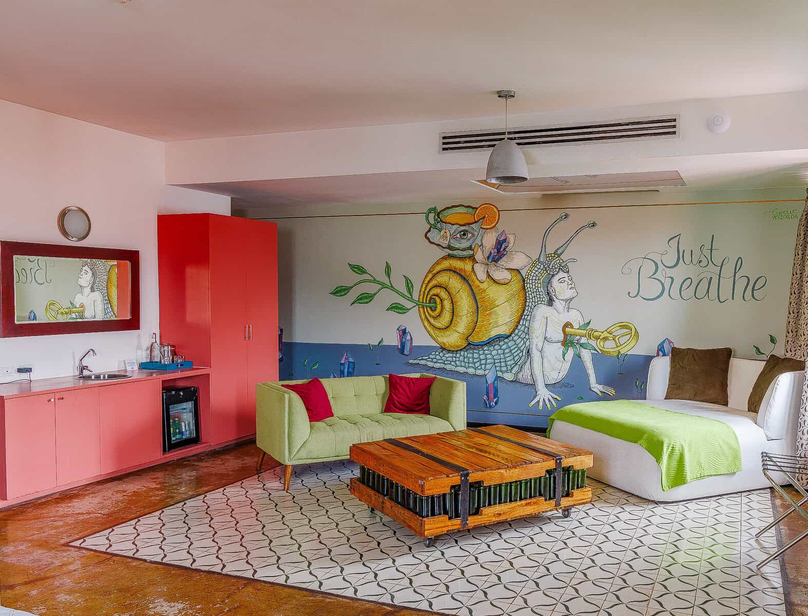 Artistic boutique hotel room at Tantalo Hotel in Casco Viejo Panama with mural wall, lounge area, and colorful design