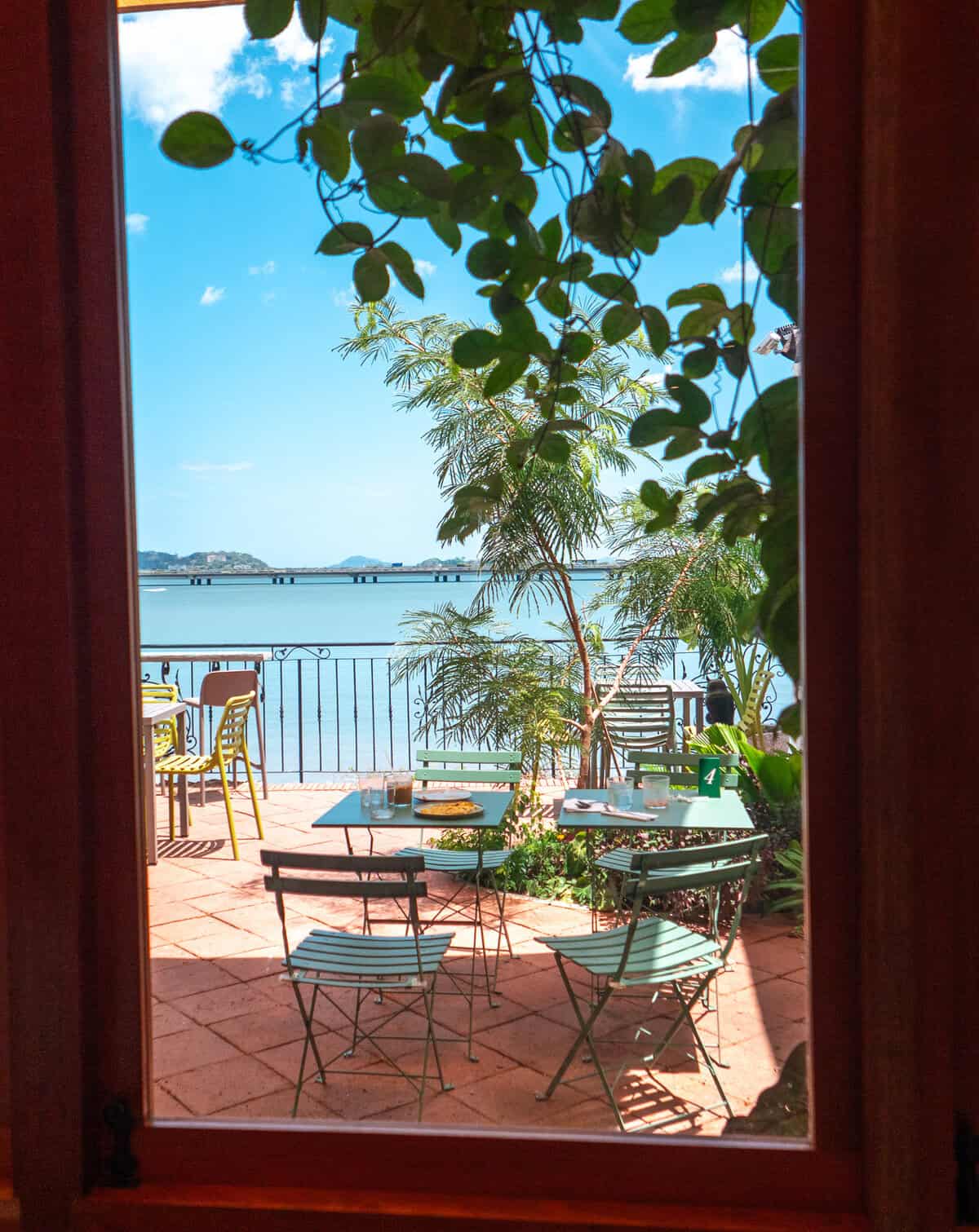 Bay view patio seating at Olympia Coffee Studio Casco Viejo Panama seen through window