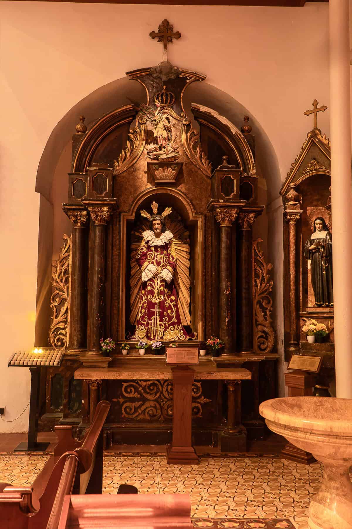 Historic devotional side altar inside La Merced Church in Casco Viejo, Panama City.