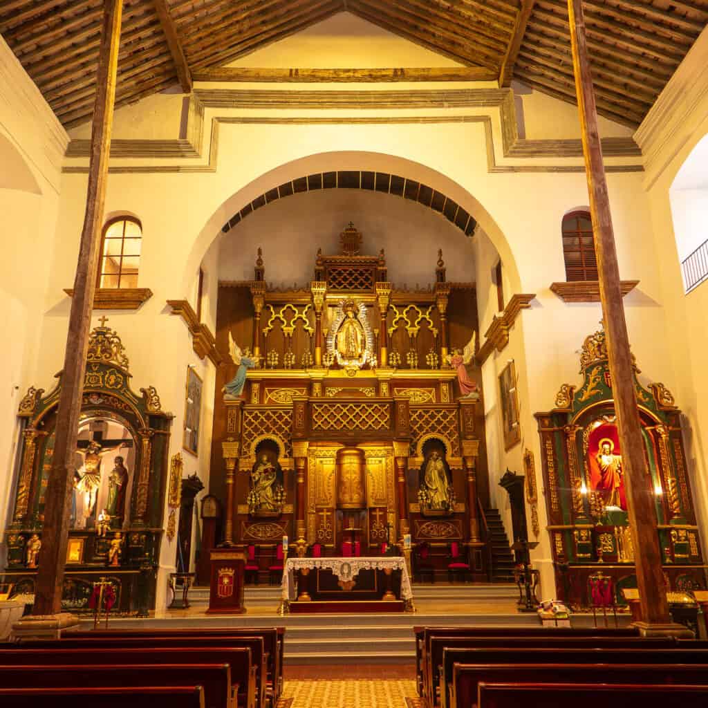 Interior of La Merced Church in Casco Viejo, Panama City, showing the historic main altar, wooden ceiling and colonial architecture.
