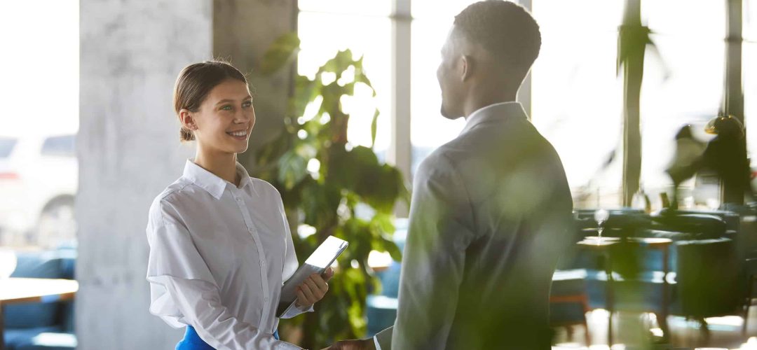 Pretty business lady shaking hand of business partner