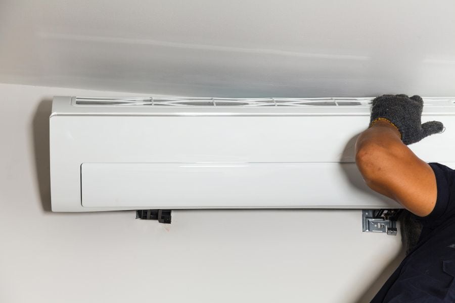 Air conditioner unit dripping water due to clogged drain line and faulty evaporator coil.